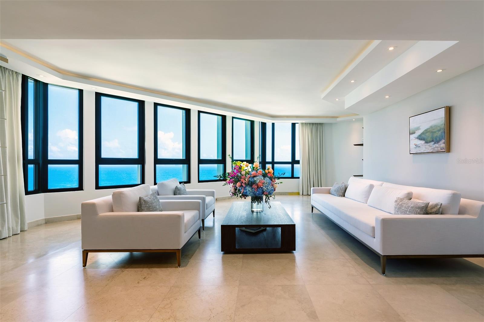 Experience the Pinnacle of Luxury at Caribe Plaza’s Sub-Penthouse
Elevate your lifestyle to new heights with this extraordinary sub-penthouse at Caribe Plaza, perched on the 20th floor. Spanning an impressive 7,187 square feet across two levels, this mansion in the sky offers unparalleled city living with breathtaking views of the turquoise ocean skyline. This is the only condo of its size currently available in San Juan, making it a unique opportunity for discerning buyers.
Begin your day by savoring your morning beverage on your private terrace, where the sweeping ocean views and vibrant sunsets create a perfect backdrop.  As night falls, the twinkling city lights provide a stunning contrast, ensuring every moment in this home is nothing short of magical.  
Upon entering your private lobby, you’ll find a spacious main level featuring a formal living and dining room, a gourmet kitchen equipped with top-of-the-line appliances and custom cabinetry, and a generous entertainment area with a bar, media space, and multiple dining options. The home is outfitted with Sonos speakers throughout, enhancing every occasion with seamless sound. This residence is ideal for hosting gatherings of any size, offering both elegance and comfort.
The second level is dedicated to restful retreats and luxury. It includes three en-suite bedrooms, a family media space, and the primary suite—a sanctuary of opulence. The primary suite boasts a spa-like bathroom with a large soaking tub, dual waterfall shower heads, a coffee station, mini fridge, double vanities, and a massive walk-in closet. The bedroom area, complete with a cozy sitting area, is enveloped by majestic ocean views.
In addition to the luxurious living spaces, this home offers practical amenities such as four deeded parking spaces, a dedicated storage room, a maid’s room/office on the first level, and a spacious walk-in laundry room. These features ensure both convenience and functionality in this exceptional residence. 
With its expansive space, stunning views, and full-service concierge building, this sub-penthouse offers a lifestyle of luxury and sophistication that truly has it all.