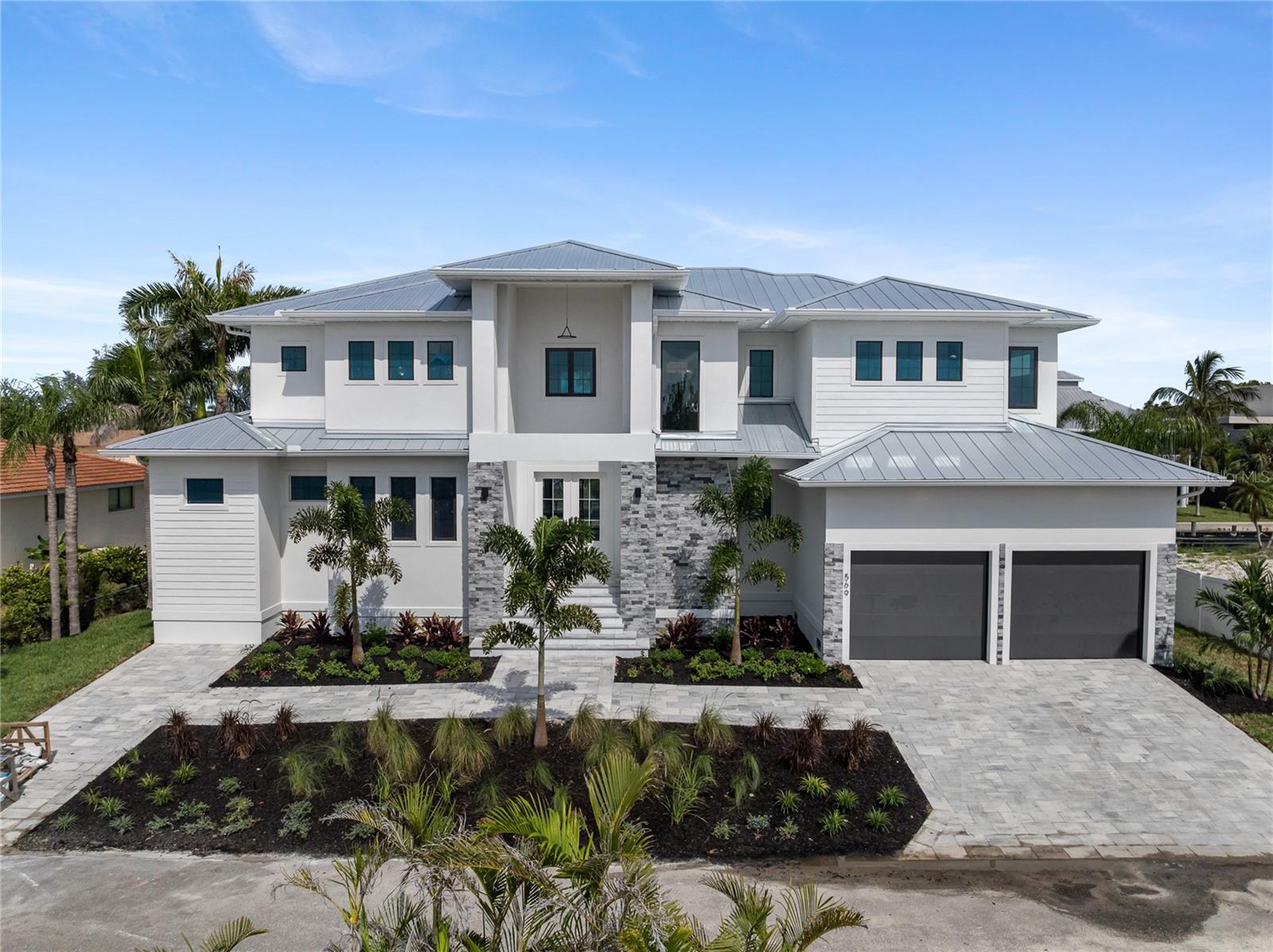 New Construction. Experience the pinnacle of waterfront luxury with this brand-new construction home in the heart of Longboat Key competitively priced and ready for its next owner. Situated on a private canal, this 4-bedroom plus den, 4,106 sqft residence offers the perfect blend of modern elegance and coastal charm. Designed for seamless indoor-outdoor living, the home features two lanais, a private pool with a spa, and an elevated foundation at 9.5 feet. Boating enthusiasts will appreciate the 10,000-lb boat dock and quick access to the Gulf of Mexico for endless days on the water. Inside, enjoy engineered hardwood flooring throughout, quartz countertops in every space, and a large walk-in pantry. The thoughtfully designed layout includes two laundry rooms for added convenience. Nestled in a quiet, private setting, yet just minutes from Longboat Key’s pristine beaches, golf courses, and fine dining, this home is a rare find. Don’t miss the chance to own a waterfront masterpiece in one of Florida’s most desirable locations.