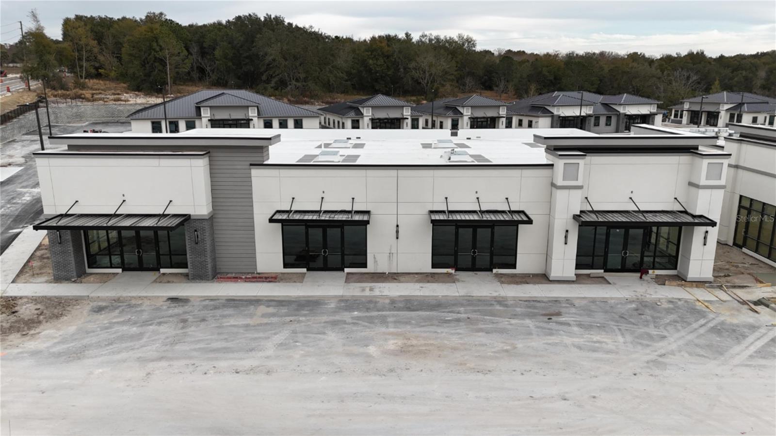 Under contract-accepting backup offers. Under Construction. Building #05 is available for purchase at Lake Carter Exchange, a distinguished mixed-use development in Apopka’s East Shore at the intersection of Ocoee-Apopka Road and W Keene Road. In addition, this building is on the corner and has visibility from both roads. This dark gray shell retail building features a customizable interior, shared patio space and dedicated end-unit patio space. The shell delivery provides buyers with maximum flexibility to design the interior layout, with four front entrances supporting up to four unique suites. The development is strategically located less than one mile from Advent Health’s seven-story, 120-bed hospital and opposite a new Publix Supermarket development. Situated in the vibrant East Shore trade area, which includes 5,000 planned residences and an average household income above $100k, this Class A property is perfectly positioned for businesses targeting growth in Central Florida’s second-fastest-growing city. Contact us for pricing details/incentives and to schedule a tour of this exceptional commercial opportunity.