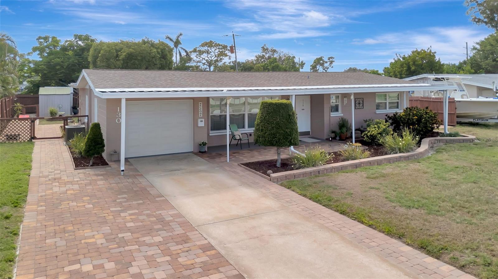 Whether you're looking for a full-time family home, seasonal Florida retreat, or investment opportunity, this property offers flexibility and location that are hard to find! Spacious 2BR/2BA home situated on a large fully fenced lot with NO HOA, NO rental restrictions, and NO flood insurance required. Located in unincorporated Manatee County outside of city limits, allowing added freedom for owners, investors, boats, RVs, trailers, or work vehicles. Designed for the Florida lifestyle, the property features a dedicated outdoor recreational area for boats and RVs with RV hookup, two storage sheds for bikes, kayaks, beach gear, and tools, plus plenty of parking for multiple vehicles. The beautifully enclosed backyard offers precisely placed paver walkways and entertaining areas, creating the perfect setting for outdoor dining, relaxing, pets, or gatherings with family and friends. An outdoor shower makes beach and boating days even more convenient.
Inside, the home features a recently painted interior, updated kitchen and bathroom spaces, hurricane rated with winds up to 175 miles an hour windows and sliders, washer and dryer included, and an extended 1-car garage with additional laundry area. Families will appreciate the oversized yard and proximity to parks, recreation, schools, hospitals, and IMG Academy. Snowbirds will love the low-maintenance setup and quick access to beaches, golf, dining, and entertainment. Investors will appreciate the lack of rental restrictions and prime location near beaches, boating, IMG, and downtown attractions. Conveniently located near public boat ramps with quick access to the Manatee River, Sarasota Bay, and the Gulf. Just minutes to the beautiful beaches of Anna Maria Island, downtown Bradenton, Riverwalk, waterfront restaurants, rooftop bars, shopping, and entertainment. Enjoy boating access to destinations including De Soto National Memorial and Emerson Point Preserve. Also close to GT Bray Park with recreation facilities and dog park, Robinson Preserve, Bradenton Country Club, public golf courses, and medical facilities. A rare opportunity offering flexibility, convenience, outdoor living, and the Florida lifestyle all in one.