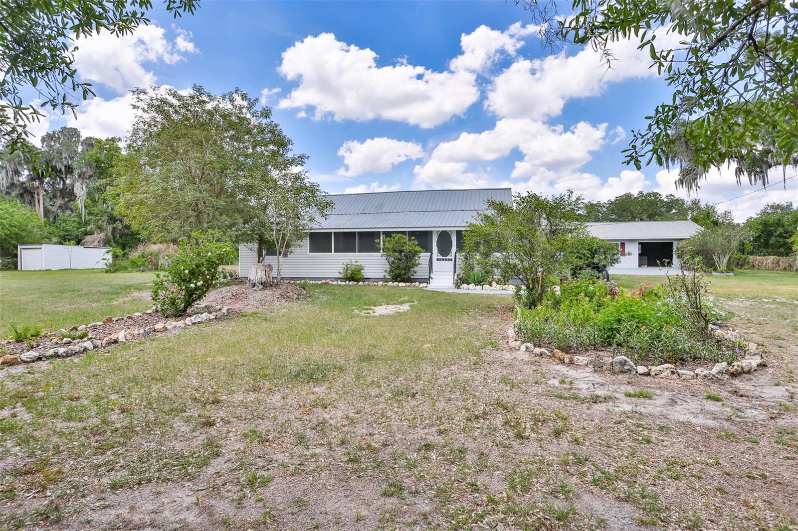 Make an offer!   TWO homes on one beautifully landscaped property—ideal for multi-generational living, guests, or rental income!

The main home, built in 1925, blends classic charm with modern updates. It was completely replumbed and rewired in 2017. A metal roof was installed in May 2004 and updated in 2025 with wood Zac screws and a cricket was installed for the chimney. The AC was installed in 2016. In 2006 water was connected to the City water system and  remains on a 1,500-gallon septic tank system. 2023 the septic tank was pumped and cleaned out. The home was freshly repainted in 2025.

Inside, the layout includes a living room, dining room, kitchen, bedrooms, and a welcoming front porch. The primary bathroom features a walk-in shower and a large closet. A bonus room just off the primary bedroom, leading to the front porch area, can be used as an additional bedroom, office, study, or flex space.

The fenced yard is a true garden retreat, featuring fruit trees including Finger Lime, Pink Variegated Lemon, Sopapilla, and Longan, along with an array of flowering trees, shrubs, and vines such as Japanese Orchid Tree, Purple Jacaranda, Hibiscus (Jamaica), and Magnolias—ensuring something is always in bloom.

The second home, built in 2006, is fully self-contained with a full kitchen and full bath, making it perfect as a mother-in-law suite, guest house, or rental opportunity. The 2nd home was built in 1974 as a garage. Then it was totally remodeled into the house it is today in 2006. It offers 2 bedrooms, 1 bath, a separate entrance, and a one-car enclosed garage. This home was rewired in 2017 and the ceiling fans were updated in the living room and one bedroom. Home features a 2023 HVAC system, and was reroofed with shingles in 2025. The interior was repainted in 2025, and brand-new carpet was installed in the bedrooms. Both homes share the same septic system.

This versatile property offers space, income potential, and a lush, private setting—an exceptional opportunity for a wide range of living arrangements.

Please call for a private showing!
