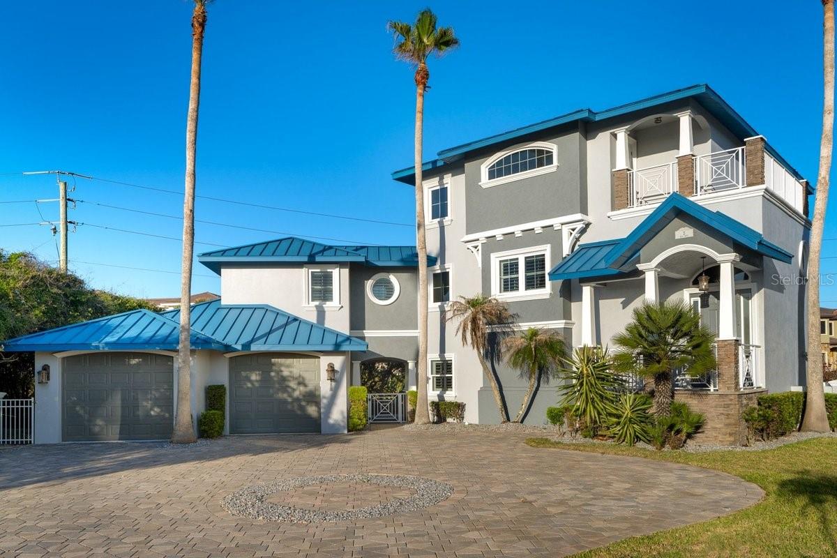 Built solid with poured concrete construction and located steps from the Atlantic, this stunning 3-story, 4-bedroom, 4.5-bath Ponce Inlet estate offers the kind of quality and lifestyle that's truly hard to find on the Florida coast. OWNER FINANCING AVAILABLE. With ocean views from all four balconies, you'll never lose sight of why you chose to live here. The heart of the home is the open-concept second floor, where a spacious living, dining, and kitchen area flows seamlessly beneath beautiful cedar plank ceilings. A gas fireplace anchors the living space, while the chef's kitchen impresses with silestone countertops, GE Monogram gas appliances, a built-in griddle, warming drawer, and infrared heating counter -- everything a serious cook could want with an ocean view to match. Step outside to one of several balconies to take in the breeze, or head down to the ground-level paver patio to unwind in the salt-water heated pool.

The entire third floor is dedicated to the master suite -- a true private retreat complete with two balconies, a walk-in closet larger than most bedrooms, and its own wet bar and coffee station and a private office with an ocean view. A private spiral staircase connects the master level directly to the second floor for effortless access. The remaining bedrooms, a dedicated office, and 3-car garage provide all the space and flexibility a family needs.
Smart home features throughout include a private elevator serving all three floors, tankless water heater, central vacuum, intercom, and security system. Located in the laid-back, uncrowded beach community of Ponce Inlet -- walk to the beach, the lighthouse, nearby restaurants, and world-class fishing. This one truly has it all.
