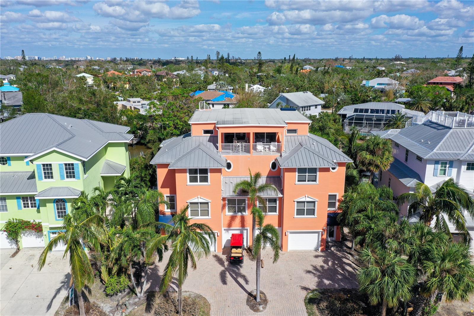 Under contract-accepting backup offers. Possible Seller Finance. High & Dry!!  BEACH, BOATING & BISTROS!!!! SIESTA KEY`CANAL FRONT featuring WEEKLY RENTALS!! DOCK & LIFT!! GULF VIEWS!! BEACH ACCESS STEPS AWAY!!!  Great location with Gulf Views steps to Public Beach Access #8 offering the ultimate waterfront lifestyle of this rare, furnished 3 bedroom/3.5 Bath plus office (or 4th bedroom), RMF-zoned opportunity on Siesta Key. Built in 2005 with high elevation and Impact Glass for peace of mind. Savor spacious living with high ceilings in 4 stories and 3,036+/- sq. ft. of living area, all accessible by stairs or private elevator, plus a ground-floor bonus room set behind the garage for your gym or office. Retreat to the large master suite, which boasts water vistas and master bath with dual vanities, granite counters, walk-in shower. Multiple terraces provide a picture-perfect panorama of your tropical setting, with each level more stunning than the last and culminating with stunning Siesta Key Beach views from the soaring top floor. Entertain with ease and style by the open, heated pool and spa, which leads to your own private dock and boatlift. Just a short boat ride on the Grand Canal to worldclass fishing and watersports. HOA is reasonably priced and lends to your comfort and convenience of maintenance-free living. Seller will also consider partial trade on storm damaged home.