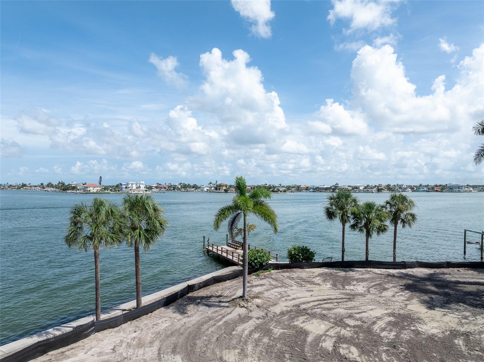 LAND! See it, Feel it, Touch it! Truly a great investment that never goes away! Discover your private retreat on this large double waterfront lot. With over 230 feet of direct water access, panoramic views of Boca Ciega Bay, and its own dock, this property is on deep water with easy access to the Gulf. These lots are primed and ready for your dream estate! Existing large Palm trees have been preserved so that any new home comes with mature tropical landscaping, framing breathtaking Florida water views! Conveniently located just ½ mile from the beach, shopping, dining, and everyday conveniences, with direct access to the Pinellas Trail and just minutes to Downtown St. Petersburg. A current survey is available and the property is also available to be purchased combined with 1 Paradise Ln. Don’t miss the chance to create your dream waterfront home. For buyers interested in a design/build firm,  Windstar Homes has designed a custom home that will fit on this lot.