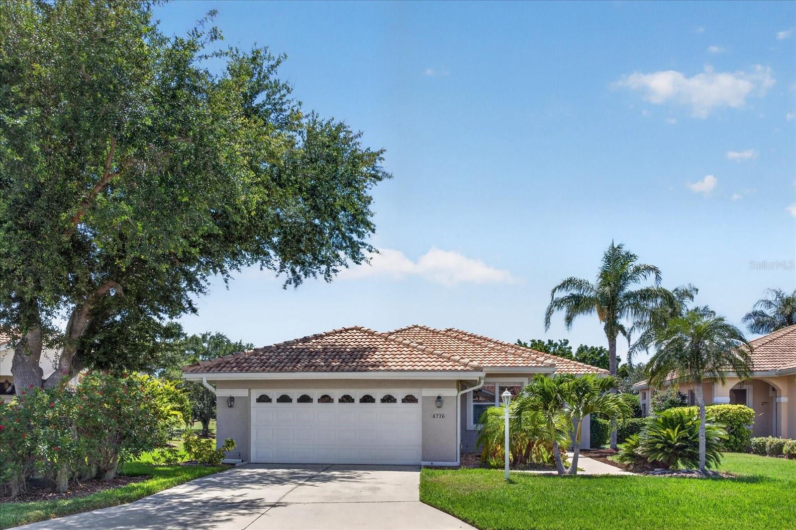 Arthur Rutenberg-designed pool home on a premium Lakewood Ranch homesite with beautiful water, tree, rolling hill, and golf course views. This upgraded residence offers a bright, open layout with high ceilings, luxury vinyl plank flooring throughout, a tile roof, and a well-designed floor plan that makes excellent use of space. The kitchen features granite countertops, stainless steel appliances, generous cabinetry, and plenty of storage, opening comfortably to the main living areas where the views take center stage. The primary suite includes a large walk-in closet, and every closet in the home has built-in closet cabinetry for exceptional organization. Additional interior highlights include ceiling fans in each room and Top-Down, Bottom-Up Cellular Shades throughout, allowing natural light and sky views while maintaining privacy from the street and neighboring homes. Outdoor living is a standout feature with an extended screened lanai, heated pool, and a private setting overlooking the pond, trees, rolling golf course landscape, and River Club Golf Course. The garage also features an epoxy floor coating for a clean, finished look. Ideally located near The River Club Golf Course, Lakewood Ranch Main Street, Lakewood Ranch Medical Center, Waterside Place, University Town Center, I-75, and SR 70, with a low HOA that includes landscape maintenance, no Lakewood Ranch CDD, no development or club fees, and no required golf membership. Available furnished or unfurnished.