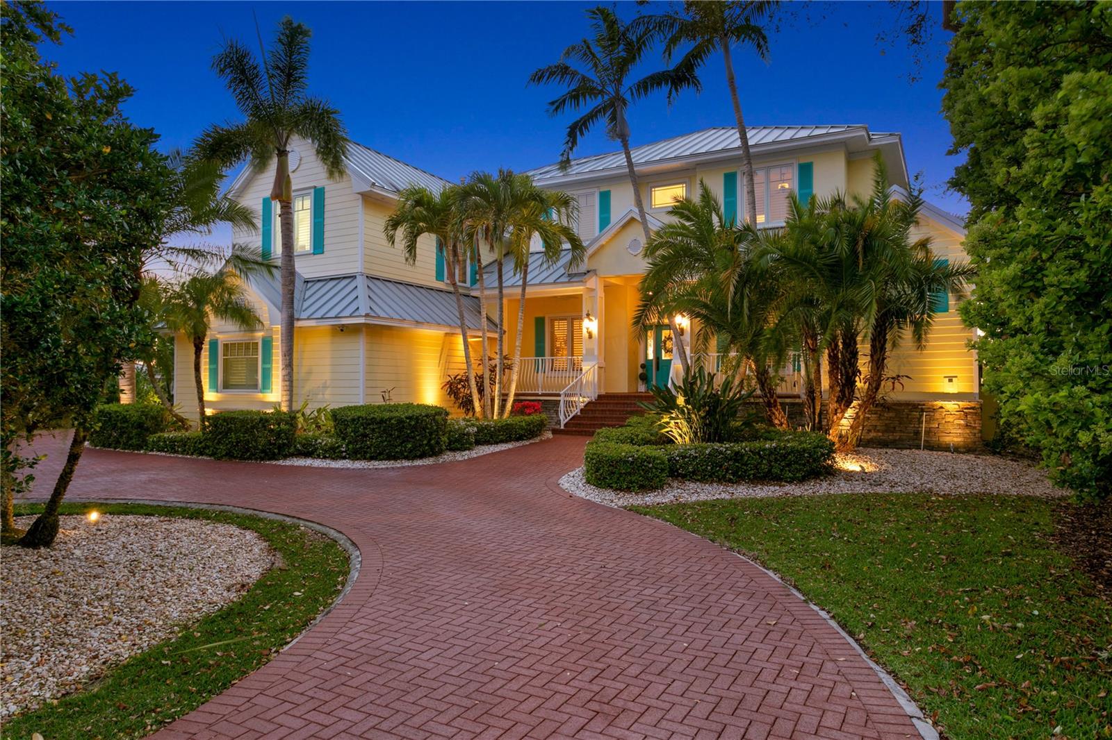 Luxurious Waterfront Living with Unmatched Convenience.

Indulge in the ultimate waterfront lifestyle with breathtaking west-facing views over Old Tampa Bay, where every evening offers a poolside seat to spectacular sunsets. This private resort-style retreat, meticulously maintained on nearly 3/4 acre lot, combines luxury, comfort, and convenience — all without the hassle of beach traffic.

Approach via a circular brick driveway, where lush tropical landscaping sets the tone for the serenity that awaits. The Key West-inspired exterior welcomes you with a charming front porch, while the grand two-story entryway features a stunning chandelier that lowers automatically for effortless cleaning.

Inside, soaring 22-foot ceilings and expansive windows, many trimmed with plantation shutters, flood the home with natural light, showcasing ever-changing water views from nearly every room. The thoughtfully designed floor plan offers a main-floor primary suite with a spa-like bath and generous walk-in closet, a private home office, and an open-concept great room anchored by a gas fireplace and custom built-ins. The gourmet kitchen is a chef’s dream, featuring Hawaiian mahogany counters, a huge walk in pantry, gas Viking range, Viking refrigerator, Asko dishwasher, trash compactor, instant hot water, and a custom exhaust hood — all opening to the great room and breakfast nook, creating the heart of the home.

Upstairs, discover three additional bedrooms, including a secondary en-suite, plus a flex room ideal for a second office, gym, or library — all with sweeping water views. The theater/game room is equipped with a wet bar, refrigerator, and a Pyramid sound & light system, making it perfect for movie nights or game day gatherings.

Step outside to your private waterfront paradise — where outdoor living is elevated by a covered patio with theme park-like misting systems, reclaimed water irrigation, a Pebble Tec saltwater pool with a sun shelf, fountain and spillover spa.  The gourmet outdoor kitchen with a beverage refrigerator and Viking gas grill will make entertaining a dream. 

The composite dock with post mount lighting features a 20,000-pound boat lift, and fish-cleaning station — offering endless opportunities for boating, kayaking, jet skiing, or simply enjoying the natural beauty of the bay as you rest on the integrated bench. 

This well-built, storm-resistant home sits up high and has had no water intrusion in the living space. PELLA windows and doors with Kevlar Hurricane Screens, whole house generator,  ADT alarm and camera security system, in-ground lightening protection, a Metal roof and new seawall cap creates a secure barrier.
Even doing laundry will be a delight with a pedestal washer, double pedestal gas dryers and a specialty handwashing sink! 

Perfectly positioned just 20 minutes to Tampa International Airport, 25 minutes to the Gulf beaches, close proximity to Berkeley Preparatory school and moments from parks, pickleball, Mobbly beach, bike trails, Veterans Memorial park, dining, and shopping — this is waterfront living without compromise.

Experience the luxury, tranquility, and convenience of this rare offering — where every day feels like a vacation.