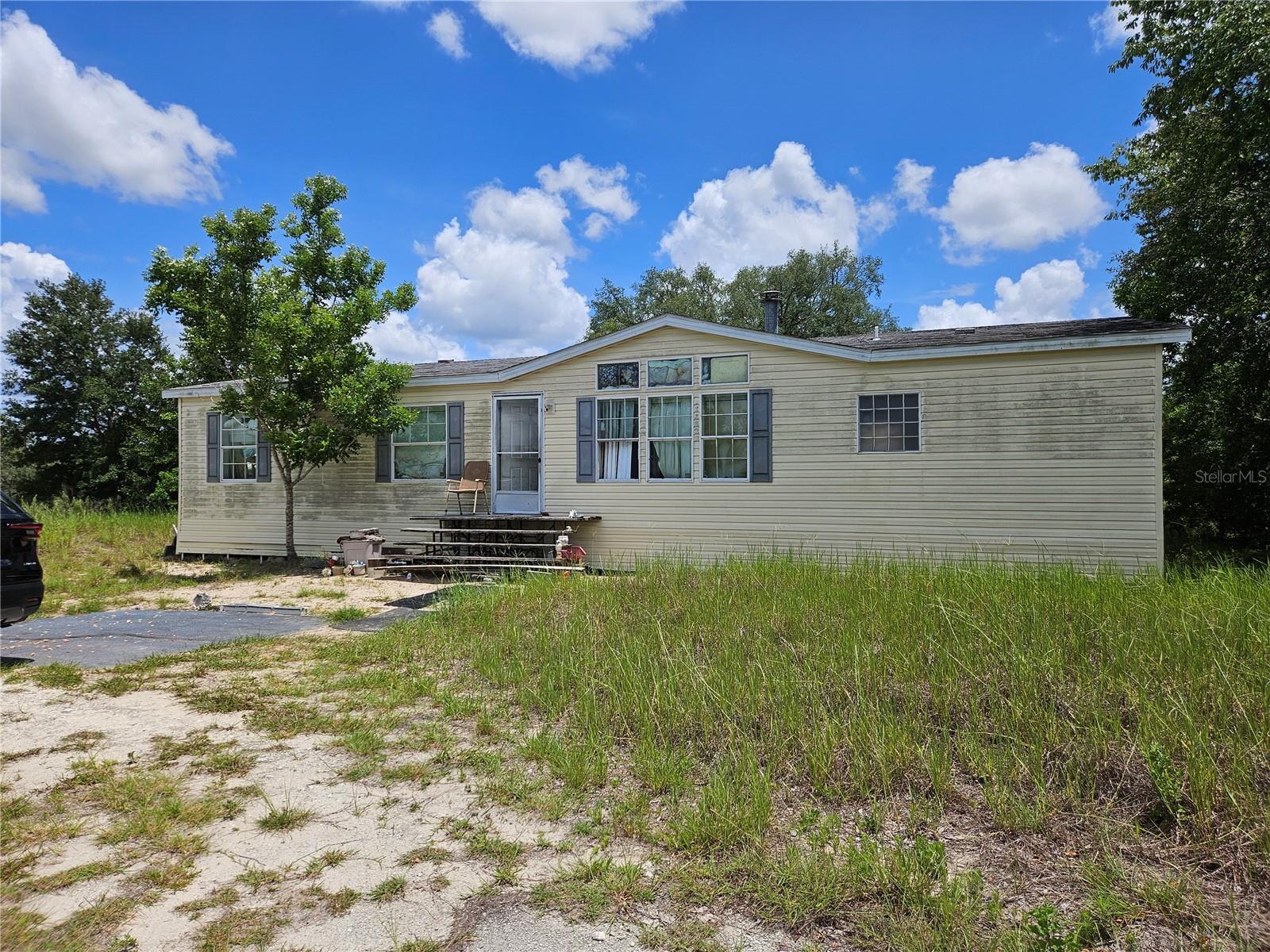 Fenced 9.38 Acres ( 644 xc 643) high and dry land.  Great to build your dream home. 5 minutes to downtown Dunnellon. 2001 mobile needs TLC, A/C not working, immediate roof replacment.