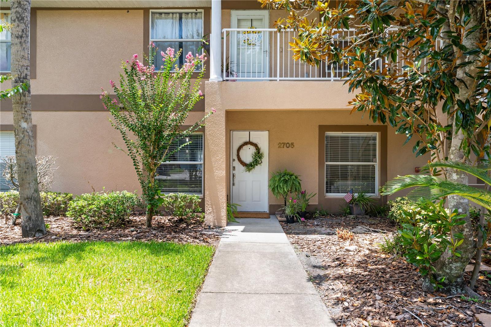Virtually Staged. Welcome to Villas of Emerald Lake, where peaceful waterfront living meets everyday convenience. This beautifully updated first floor condo offers 2 bedrooms, 2 bathrooms, 1,240 square feet of comfortable living space, and a setting that's hard to find. Inside, you'll love the remodeled kitchen featuring quartz countertops, updated lighting, and wood-look tile throughout the main living areas. A wet bar, inside laundry closet, and detached one-car garage with an automatic opener add everyday convenience. The living room opens to a screened patio overlooking Fish Lake and your private dock, creating the perfect place to enjoy your morning coffee or unwind at the end of the day. The spacious primary suite features a walk-in closet with a window overlooking the lake and an en suite bathroom with a relaxing garden tub. Residents also enjoy a community pool, mature oak trees, and beautifully maintained grounds. Tucked away on a quiet street just off Highway 192, this hidden gem is ideally located on the border of St. Cloud and Kissimmee, less than five minutes from shopping, dining, medical facilities, and the Florida Turnpike. You'll also enjoy easy access to Downtown St. Cloud, Downtown Kissimmee, Orlando International Airport, and the Brightline station. If you've been looking for a move-in-ready home that offers low-maintenance living, peaceful water views, and an unbeatable location, this is one you won't want to miss.