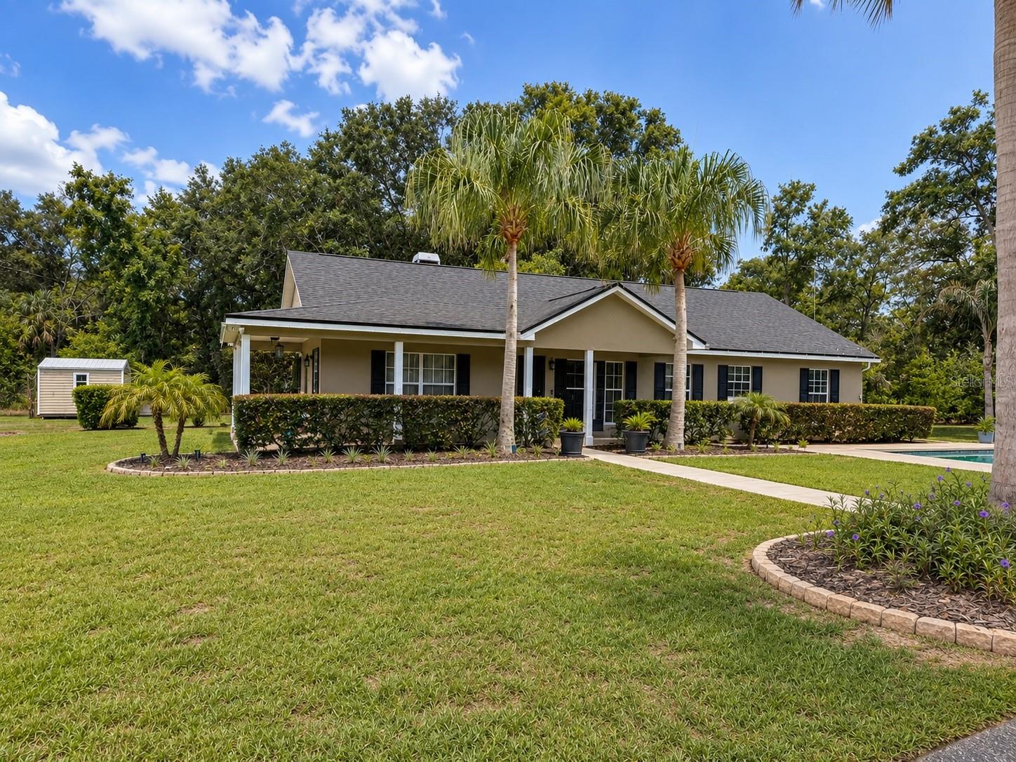 One or more photo(s) has been virtually staged. Welcome to your private country retreat! Situated on 5 beautiful acres of agriculturally zoned land, this exceptional Eustis property offers the perfect blend of space, comfort, and freedom with no HOA restrictions and located in a non-flood zone.

Designed for both everyday living and entertaining, the home features a warm and inviting fireplace, creating the perfect gathering space for family and friends. Outside, you’ll discover an impressive combination of amenities including a pool, carport, and workshop, all thoughtfully positioned to flow together beautifully for entertaining, gatherings, and enjoying Florida’s outdoor lifestyle.

Enjoy peace of mind with a new roof installed in 2025, while the agricultural zoning and expansive acreage provide endless possibilities for animals, gardening, equipment storage, hobby farming, recreational activities, or simply enjoying the privacy and tranquility of country living.

Whether you’re seeking a private homestead, a place to entertain, or room to pursue your passions, this unique property delivers the lifestyle you’ve been searching for—all while remaining conveniently located near shopping, dining, and everyday conveniences.