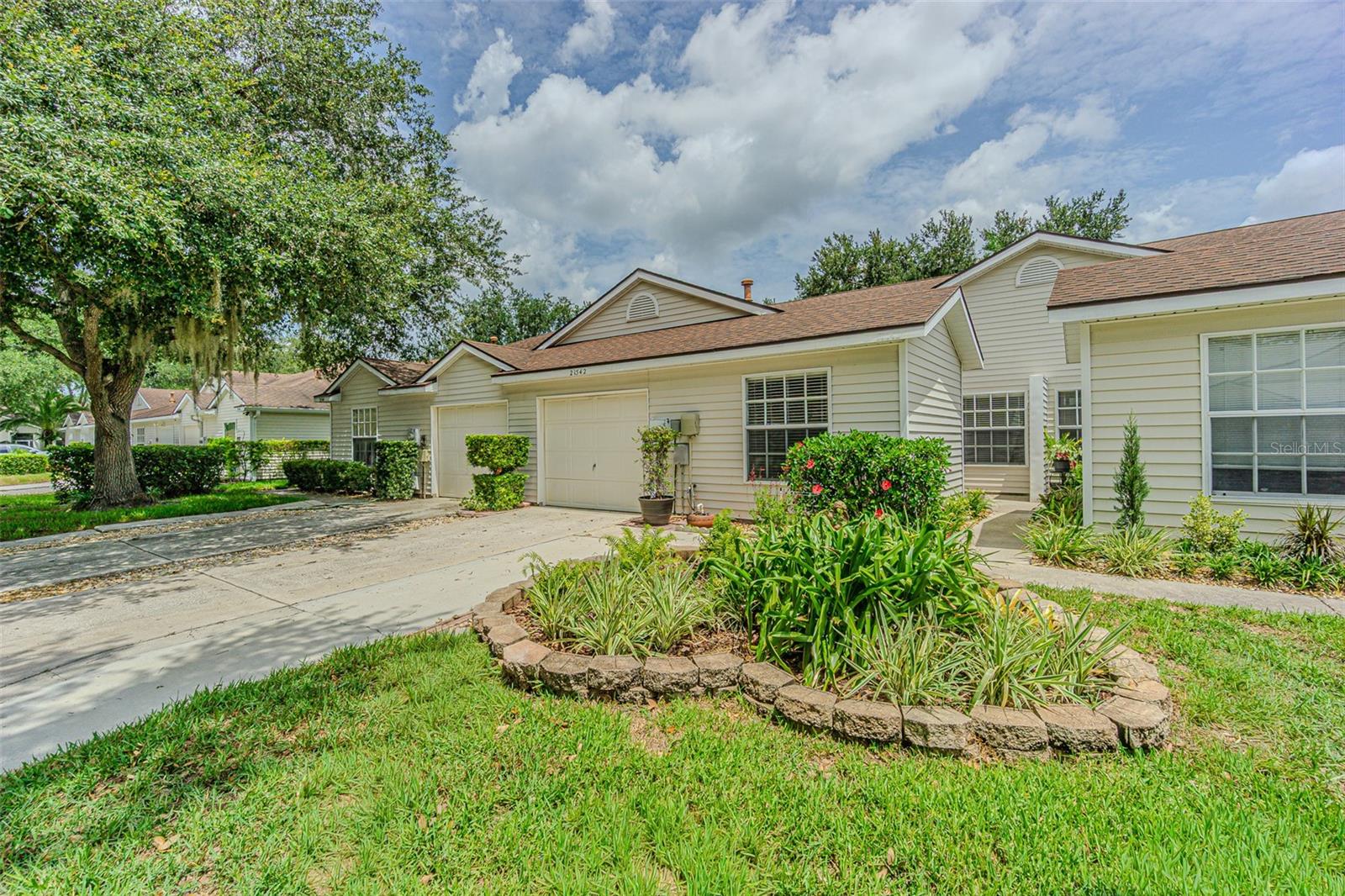 Light-Filled, renovated-villa Living in Lake Heron – 21542 Clubside Loop, a rare one-story unit villa in the highly desirable Lake Heron townhome community of Lutz. Homes that check this many boxes—and show this well—are the ones that move fast. From the moment you step inside, you’ll notice the enhanced luxury vinyl plank flooring and 5 1/4" baseboards throughout the entire house. The open-concept layout features a beautifully updated kitchen with Quartz countertops, stainless steel appliances, cathedral ceilings, and a seamless flow into the dining and living rooms—perfect for everyday living and entertaining. Walk from the living room out to the screened porch with full windows, creating a bright, relaxing space to enjoy morning coffee or evening breezes year-round (with a northern view). The primary suite is a true retreat, offering generous space and an ensuite bath with Quartz countertops, dual vanities, and an updated shower. Two additional bedrooms provide flexibility for guests, a home office, or hobbies. Outside, the 1-car garage is complemented with great landscaping. Lake Heron amenities elevate the lifestyle with a clubhouse, pool, tennis & pickleball courts, a scenic lake with brick walking paths, waterfront gazebo, and expansive green spaces—all just a block away from home. This home is ideal for a turnkey primary residence, second home, or low-maintenance Florida living. 3 Bedrooms | 2 Bathrooms | 1,288+ Sq Ft | Interior Unit | Homes like this—single-story, updated, light-filled, and move-in ready—consistently sell quickly in this area. Schedule your private showing today and see why this one stands out.  Beautiful luxury vinyl plank flooring is approximately 2-3 years old and the HVAC was updated in 2016. The roof/siding is the responsibility of the HOA. Love the low maintenance living with these new upgrades!