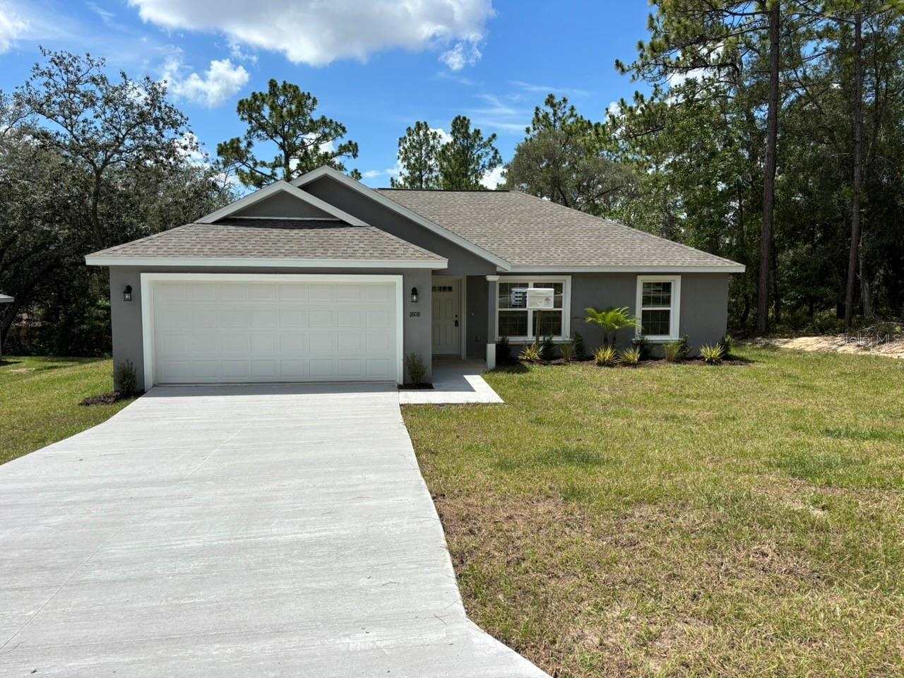 NEW CONSTRUCTION. MOVE-IN READY! The Key West Model in Citrus Springs offers 3 bedrooms, 2 bathrooms, and 1,405 square feet of comfortable living space. Built for lasting value, this home features concrete block construction, a 30-year architectural shingle roof, energy-efficient double-pane windows, and a 10-year structural warranty. Inside, the open, split-bedroom floor plan features vaulted ceilings and luxury vinyl plank flooring throughout. The kitchen includes stainless steel appliances, custom white shaker cabinets with soft-close drawers, granite countertops, and a pantry. Both bathrooms also feature granite countertops for a clean, coordinated finish. Additional features include a washer and dryer, blinds, a covered patio, sliding glass doors, privacy fence along the back of the property, and an attached 2-car garage with an opener and remotes. Enjoy ownership freedom with no HOA fees, plus a high-and-dry location in Flood Zone X, where flood insurance is not required.