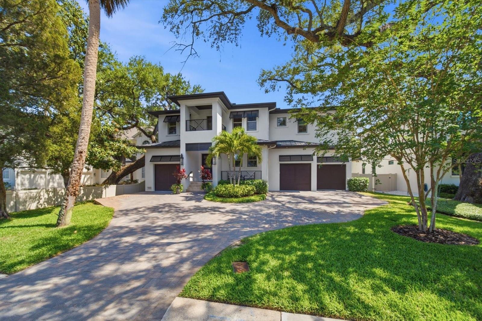 Under contract-accepting backup offers. Luxury, lifestyle, and location come together seamlessly in the heart of highly coveted Sunset Park. Nestled along picturesque oak-lined streets on an expansive 10,000+ sq ft lot, this exceptional home offers walkability to top-rated schools and unbeatable convenience to Hyde Park, Bayshore Blvd, downtown Tampa, premier shopping, major highways, and just a short drive to St. Pete and Florida’s world-famous beaches.

Designed for effortless living, this move-in ready residence is packed with high-end upgrades already completed—plantation shutters, designer lighting, custom trim work, custom built-ins, water purification system, and more—offering the feel of brand-new construction without the added expense.

Step through the solid mahogany front door into a grand two-story foyer that immediately sets the tone for the home’s elegant design. The chef’s kitchen is truly a showpiece, featuring Thermador stainless steel appliances, a 48” built-in refrigerator, double oven range, marble countertops, farmhouse sink, oversized island, hidden walk-in pantry, and a butler’s pantry with wine refrigerator. The kitchen opens seamlessly to the spacious family room with a gas fireplace and stone surround, creating the perfect setting for everyday living and entertaining. Just off the living space, discover a hidden bar tucked inside a closet—perfect for entertaining in style.

The thoughtfully designed floorplan includes a formal dining room with tray ceiling, private guest suite with full bath, and a functional mudroom with built-in bench and additional plumbing. Upstairs, enjoy a spacious bonus room and loft, along with three oversized secondary bedrooms featuring en-suite baths and walk-in closets. The luxurious primary suite feels like a private retreat with tray ceilings, a stunning marble fireplace, custom walk-in closets, and a spa-inspired bath complete with marble vanities, soaking tub, and rain-head shower. Dual laundry rooms upstairs and downstairs add everyday convenience.

Pocket sliding doors create seamless indoor-outdoor living, opening to a covered lanai with tongue-and-groove ceiling, fully equipped outdoor kitchen, and a resort-style pool and spa with screen enclosure for year-round enjoyment. The turf backyard provides a lush, low-maintenance outdoor space perfect for entertaining and play.

Additional highlights include oil-finished engineered hardwood floors, a 3-car garage with 15-foot ceilings ideal for lifts, impact Low-E windows, 8-foot solid core doors, smart home pre-wire, professional landscaping, and countless custom upgrades throughout.

A rare opportunity to own a meticulously upgraded luxury home in one of South Tampa’s most desirable neighborhoods.