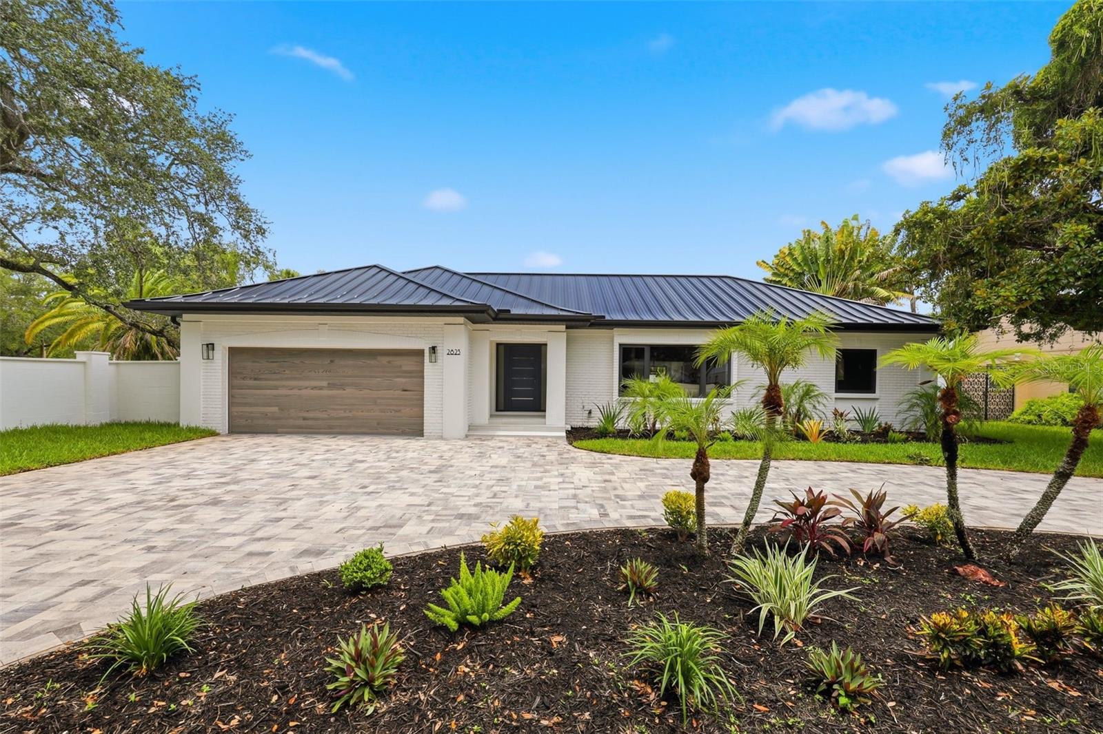 From the moment you arrive, it's clear this is anything but an ordinary home. Completely reimagined from top to bottom, this exceptional 3-bedroom, 3-bath residence offers the feel of new construction with brand new plumbing, brand new electrical, a brand new metal roof and a brand new in-ground pool. Inside, the bright open-concept layout is filled with natural light and seamlessly connects the spacious living room, dining area, and stunning eat-in kitchen featuring stainless steel appliances, recessed lighting, custom cabinetry, quartz countertops, a stylish tile backsplash, and a large center island with barstool seating. The private primary suite offers a walk-in closet and a beautifully appointed en-suite bath with dual vanities and a tiled walk-in shower, while the two additional bedrooms share a Jack-and-Jill bathroom with dual sinks and a walk-in shower. A third full guest bath is conveniently located just off the family room, providing added comfort and convenience for visitors and everyday living. Step outside to an oversized fenced backyard designed for entertaining, complete with a sparkling in-ground pool and relaxing spa. Situated in a non-flood zone, this South Tampa home is just minutes from Hyde Park Village, Bayshore Boulevard, Downtown Tampa, the Tampa Riverwalk, and Tampa International Airport, with easy access to top-rated dining, shopping, parks, and some of the area's best Gulf beaches. This is a rare opportunity to own a move-in-ready home that truly has it all, schedule your private showing today before it's gone!