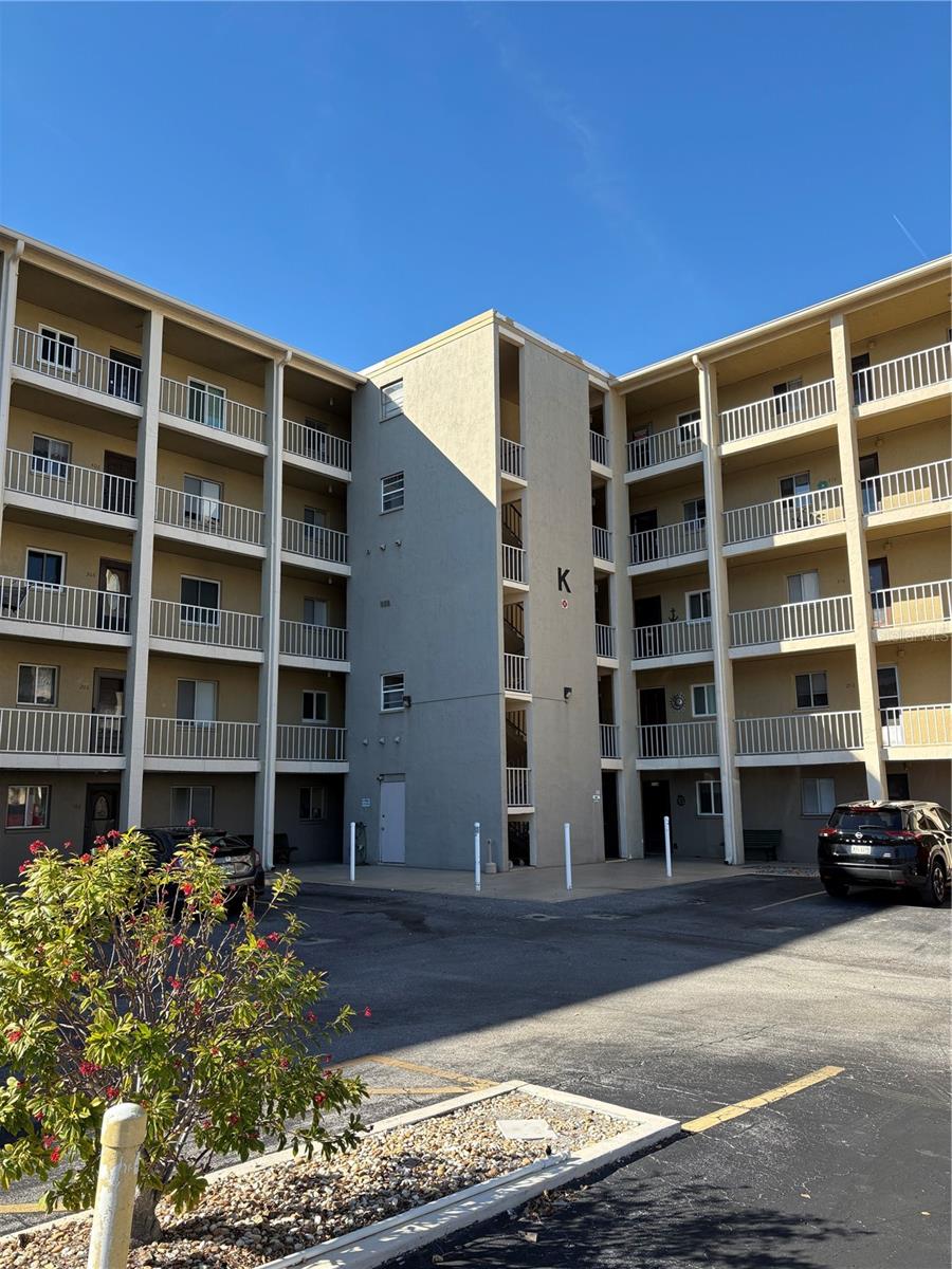 PRICED TO SELL!!! FURNISHED first-floor 2 bed/2 bath condo in the desirable 55+ Bayshore community where your parking spot is steps from your front door! Welcome to easy Florida living! This inviting residence offers a comfortable and functional layout with abundant natural light, a spacious living and dining area and a well-appointed kitchen with ample cabinetry. The generously sized primary bedroom has a large walk-in closet, and the ensuite bathroom is completely redone. There’s a second bedroom and full bathroom making it perfect for guests. Enjoy relaxing mornings or peaceful evenings on the screened lanai. Residents enjoy access to community amenities including a heated pool, clubhouse, and scenic walking paths around the lake. Conveniently located near shopping, dining, medical facilities, and just a short drive to the beautiful Gulf beaches of Anna Maria Island. Whether you're looking for a seasonal getaway, full-time residence, or investment opportunity, this charming condo offers exceptional value in a welcoming community. Highlights include: first floor walk-up with assigned parking space just outside the unit, roof was redone by association about 2 years ago. Laundry Hookups in unit. SOLD FURNISHED - except for a few select personal items.