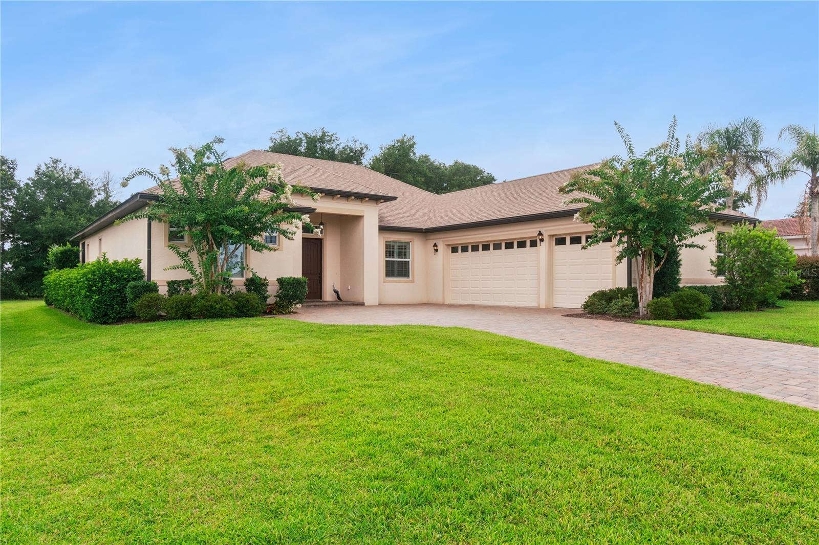 Under contract-accepting backup offers. Welcome to 5344 Sandy Hill Lane, an exceptional Sago model nestled within the exclusive gated community of Harbor Hills Country Club. Thoughtfully designed and impeccably maintained, this beautiful residence combines elegant design, modern comfort, and the unmatched lifestyle of one of Central Florida’s premier private golf communities.  From the moment you arrive, the home’s impressive curb appeal sets the stage with its paver driveway, manicured landscaping, and inviting covered entry. Inside, soaring ceilings, abundant natural light, plantation shutters, and an open, flowing floor plan create a warm yet atmosphere that is ideal for both everyday living and entertaining.
At the heart of the home is a stunning gourmet kitchen featuring an oversized granite island, stainless steel appliances, abundant cabinetry, designer tile backsplash, and generous workspace—all overlooking the spacious great room and dining area. Whether hosting family gatherings or enjoying a quiet evening at home, this thoughtfully designed space brings everyone together.  The private owner’s suite offers a peaceful retreat with ample space for a sitting area and a luxurious spa-inspired bath complete with dual granite vanities, a soaking tub, oversized walk-in shower, and two spacious walk-in closets.  A versatile flex room provides endless possibilities as a home office, den, music room, library, or hobby space, while the split-bedroom layout offers comfort and privacy for family and guests alike.  Step outside to the screened lanai and unwind while overlooking a beautifully landscaped backyard with no rear neighbors, creating a peaceful, private setting perfect for morning coffee, evening cocktails, or simply enjoying Florida’s year-round outdoor lifestyle.  Living in Harbor Hills means enjoying far more than just a beautiful home. Residents experience an exceptional country club lifestyle featuring a championship golf course, elegant clubhouse, restaurant and lounge, fitness center, swimming pool, tennis and pickleball courts, scenic walking paths, and a private marina providing access to the Harris Chain of Lakes. Conveniently located just minutes from The Villages, shopping, dining, medical facilities, and entertainment, Harbor Hills offers the perfect balance of tranquility and convenience.  Luxury, privacy, and an exceptional lifestyle await in this move-in ready home—where every day feels like a vacation.