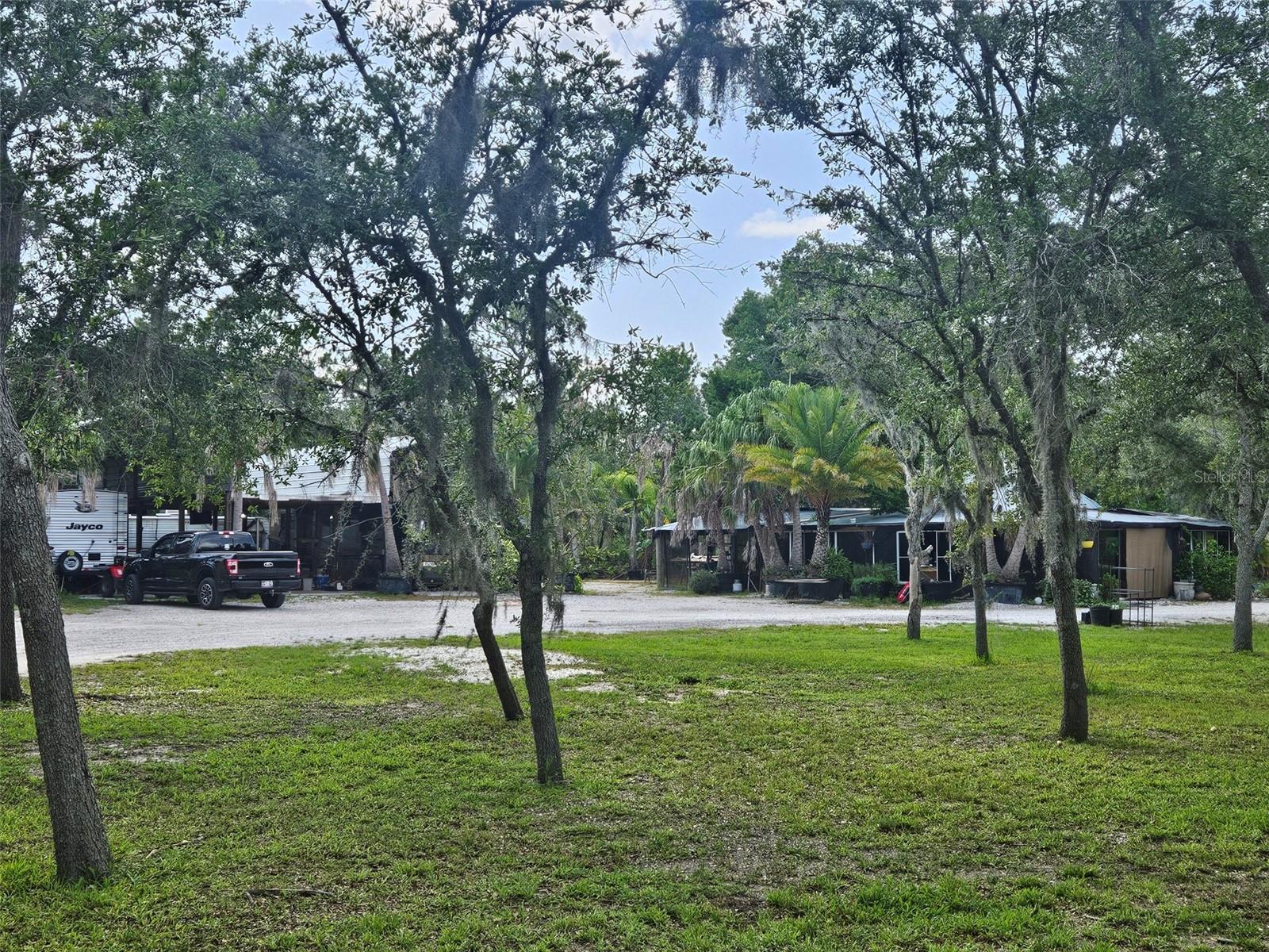 5 acres of high and dry, impacted land. With over 300 manicured fruit and palm trees. 2 electrical boxes have been impacted on site, 3 RV pads, 2 septic systems, well water system, the list of trees on site include figs, mangos, avocados, Lemons, limes, key limes, oranges, tangerines, pomelo, jackfruit, starfruit, persimmons, pomegranates, bananas, dragon fruit, loquat, papayas, peaches, plums, cherries, guava, blackberries, palm trees, limequat, and kumquat. Property is high and dry. This property is an oasis and is easy to access. 5 acres of pristine manicured cleared land with fruit, palms, RV pads, septic systems, and electric.