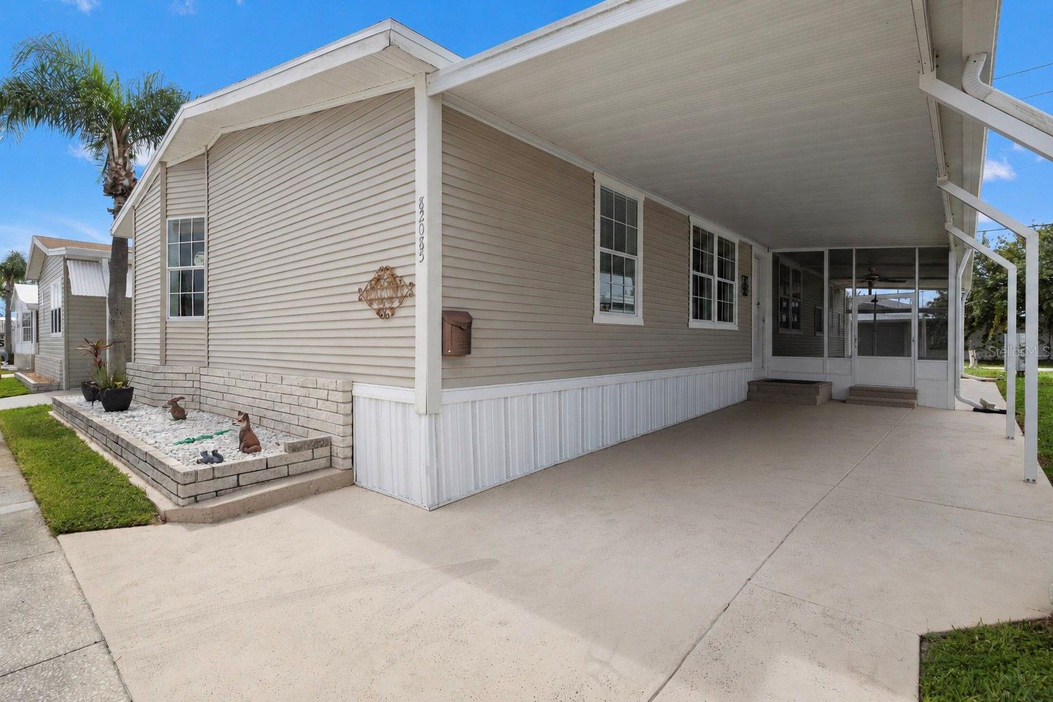 GOLDEN GATE SHOWPLACE! Welcome to easy Florida living in one of Pinellas County's premier 55+ active communities. This stunning Palm Harbor-built home features 3 bedrooms, 2 full bathrooms, and over 1,800 square feet of beautifully designed living space. From the moment you step inside, you'll be impressed by the soaring ceilings, open-concept floor plan, and spacious living room that's perfect for entertaining family and friends. The heart of the home is the chef's kitchen, complete with a large center island, breakfast bar overlooking the living room, built-in desk, beautiful solid-surface countertops, abundant wood cabinetry, and generous storage. The spacious primary suite is a true retreat featuring a soaking garden tub, dual vanities, a separate tiled shower, an oversized walk-in closet, and private exterior access. The guest bedrooms are generously sized, with one featuring a large closet and the other an oversized walk-in closet. A spacious mudroom/laundry room includes a built-in bench, Samsung front-load washer and dryer, an additional refrigerator, and convenient exterior access. Enjoy peace of mind with a new roof (2025) and new A/C (2024) complete with a transferable warranty. Being sold furnished, this move-in-ready home also includes an EZ GO golf cart with charger, making it easy to cruise through the community and enjoy the Florida lifestyle. Outside, you'll appreciate the low-maintenance vinyl siding, covered carport, screened-in porch, rear road access with extra parking, and attractive brick landscaping that enhances the home's curb appeal. Golden Gate is a vibrant, amenity-rich community with an incredibly low monthly fee of only $220. Residents enjoy a heated swimming pool and spa, shuffleboard courts, horseshoe pits, bocce ball, clubhouse, billiards room, and a full calendar of social events and activities. Ideally located, you're just minutes from award-winning Gulf beaches, downtown St. Petersburg, shopping, restaurants, grocery stores, medical facilities, and entertainment. Tampa and Tampa International Airport are a short drive away, making travel and exploring the area incredibly convenient. If you've been searching for a spacious, beautifully maintained, furnished home in an active 55+ community, this exceptional property checks all the boxes. Schedule your private showing today!
