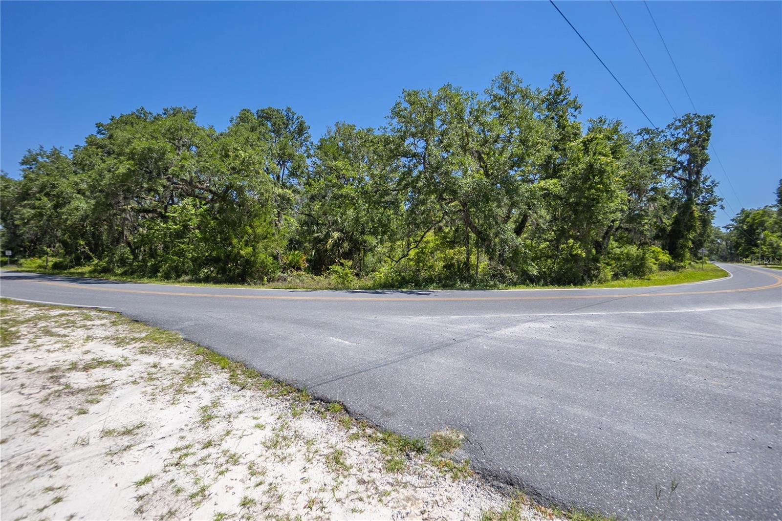 Got dreams bigger than your backyard? How about 8 whole acres to stretch out, build up, or just go wild with your imagination? Welcome to 105 NE 239th Ave—where two parcels (one 6 acres, one 2 acres) are teaming up to make your land-owning fantasies come true. Want all 8 acres? Great. Want just one of them? Also great. We’re flexible like that. The 6-acre parcel even comes with a well and septic system (we’re not saying they’re in perfect shape, but hey—they’re there). You’ve got paved road access, a sweet corner lot setup, and a wooded landscape that’s basically a Florida jungle gym. Whether you’re building a homestead, a weekend retreat, or your own “no neighbors ever” zone, this place has potential written all over it. Bring your boots, your blueprints, and your big ideas—this land is ready when you are.