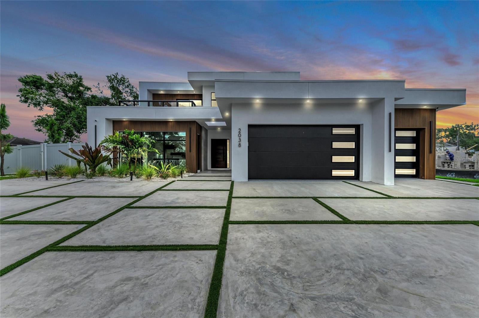Construction completed with new photos as of 5/1/2025 - Ask us about builders' incentives -  Welcome to your luxurious retreat on Datura St in Sarasota, Florida! Blending modern design with exceptional amenities, this stunning high-end home represents the epitome of modern Florida living. As you approach the property, you'll be greeted by the inviting exterior adorned with engineered-wood siding and elegant tile cladding. The grand custom entry door sets the tone for the luxury that awaits inside. Step into the open-concept first floor, where the spacious living, dining, and kitchen areas seamlessly flow together, perfect for both daily living and entertaining guests. The kitchen is a chef's dream, featuring custom cabinetry, quartz countertops, a backsplash, and high-end Sub-Zero and Wolf appliances. The large island with waterfall edges provides ample meal preparation and casual dining space. Natural light floods the room, enhancing its warmth and charm. The first floor also boasts an en-suite master bedroom, complete with a large bathroom and a spacious walk-in closet. The master bedroom opens onto the patio, offering direct access to the beautiful pool deck. Additionally, there is a den, powder room, laundry room, and a spacious 3-car garage on this level, all complemented by tall ceilings throughout. Ascend the custom floating staircase to the second floor, where you'll find three more en-suite bedrooms, each offering privacy and comfort for family members or guests. A theatre room is perfect for movie nights, while an office offers a quiet retreat for work or study. Another laundry room adds convenience to this level. Step out onto the expansive rear balcony, accessible from two of the bedrooms, and take in the breathtaking views of the pool deck below. This covered balcony provides an ideal spot for relaxing and enjoying the serene surroundings, and features a custom aluminum pergola. Outside, the pool deck beckons with its sparkling pool and spa, surrounded by lush landscaping. The covered patio area features a custom outdoor kitchen and entertaining space, perfect for hosting gatherings and creating lasting memories with family and friends. With its modern design, luxurious amenities, and prime location in Sarasota, this property on Datura St offers the ultimate in upscale living. Don't miss your opportunity to make this exquisite residence your own! Schedule a showing today.