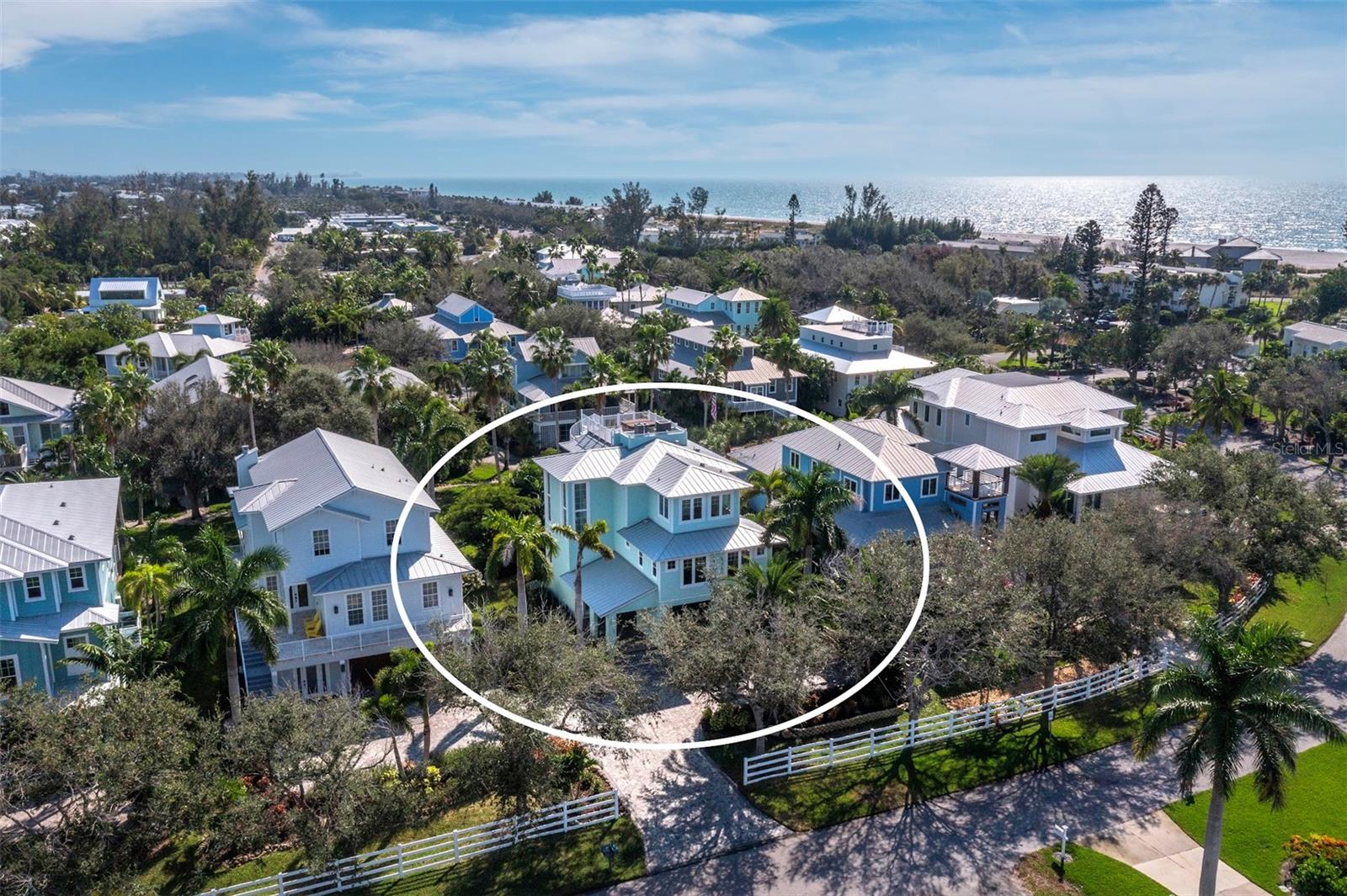 Virtually Staged. Experience the best of Longboat Key living in this elevated coastal retreat, ideally located in the desirable Conrad Beach community just a block from the Gulf of Mexico. Designed with timeless style and modern comfort in mind, this 4-bedroom, 4.5-bath residence offers sophisticated finishes, smart upgrades, and all the pleasures of island life without the upkeep of a private pool. Spanning 2,900 square feet, the open-concept layout showcases a chef’s kitchen with an oversized quartz island, premium appliances, and generous counter space ideal for entertaining family and friends. Light-filled second-level living and dining spaces open to an expansive porch and outdoor dining space , creating a seamless indoor-outdoor flow. The first living level features a serene primary suite with a spa-inspired bath and private balcony, offering a peaceful retreat. Upstairs guest suites provide privacy and comfort, with terraces to capture the island’s cooling breezes and glowing Gulf sunsets. A stunning rooftop deck with jacuzzi crowns the home, creating an unforgettable setting for evening relaxation or gatherings under the stars. Additional highlights include impact-rated windows and doors, elevator ready,  and a two-car garage with ample storage. The award-winning Conrad Beach community offers a recently renovated resort-style pool with bath facilities and beautifully maintained landscaping, all just a short stroll from the shoreline. Enjoy the vibrant charm of nearby Anna Maria Island, Longbeach Village dining, marinas, and boutique shopping at St. Armands Circle and Sarasota. This home blends coastal sophistication, privacy, and comfort—an ideal winter haven to share with family and friends.