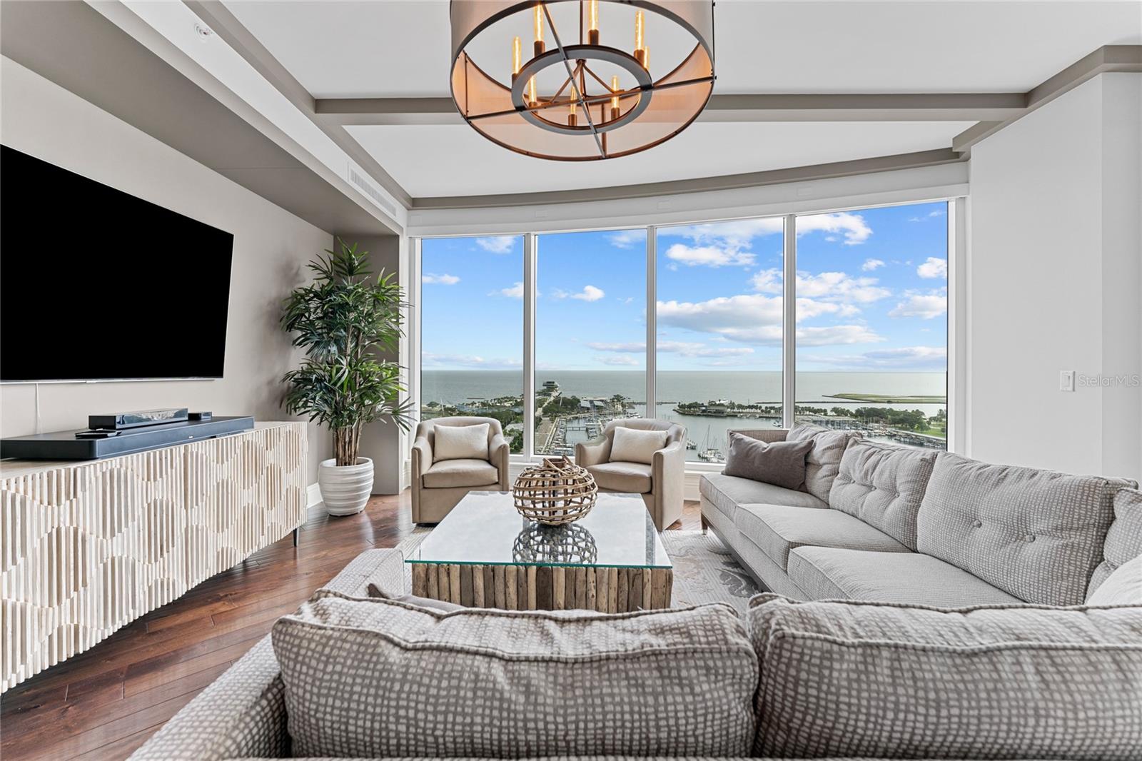 Indulge in the epitome of downtown St. Petersburg's finest luxury living at Ovation Residences, an exclusive Beach Drive tower boasting 180-degree water views, including the iconic St. Petersburg Pier, the sparkling waters of Tampa Bay, and the vibrant downtown skyline. Ideally situated just steps away from the lively Beach Drive, and minutes away from St Petersburg Marina, and Albert Witted Airport this refined urban boutique residence offers an unparalleled living experience. Arrive to unit 1602 in style via your private elevator, whisking you to the 16th floor where the doors open directly to your foyer entry. The 10 ft ceilings and floor-to-ceiling windows frame astonishing water views from every angle. This meticulously designed 3-bedroom, 3.5-bathroom condo spans over 3600 sq ft of open concept living space with engineered hardwood floors throughout. Four private terrace balconies offer additional spaces for relaxation and outdoor enjoyment. The kitchen, adorned with Wolf appliances, a Sub Zero stainless steel refrigerator, and an oversized island with counter seating, is a culinary haven for gathering and entertaining. The primary bedroom is a grand retreat, also featuring floor to ceiling windows, custom owners' closets, and an en-suite bathroom with a separate shower and soaking tub. Discover a private bonus room for an office or yoga room off the main living area. Down the hall, two guest suites await with ensuite bathrooms, more floor-to-ceiling windows, and private terraces. In the evenings, be captivated by the ambient lights of the St. Pete Pier and the marina. This condo defines contemporary luxury, providing an unparalleled lifestyle with included conveniences such as two assigned parking spaces, a private Tesla charger, a climate-controlled storage area, and access to impressive amenities. Ovation residents enjoy a rooftop heated pool, cabanas, spa room, state-of-the-art fitness center, catering kitchen, community rooms, 24-hour concierge, and top-rated security. If you're ready to reside in the lap of luxury, relish unbeatable views, and wake up to glorious sunrises every morning, all while having downtown's offerings at your fingertips, look no further. This is the epitome of sophistication at one of Beach Drive's most prestigious addresses.