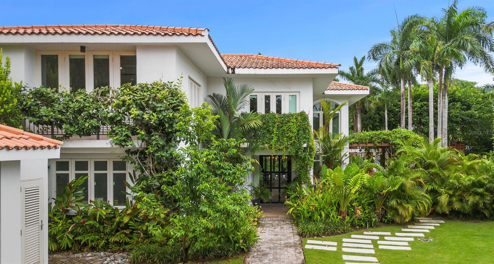 Welcome to 52 Dorado Beach East, a hidden gem nestled in the renowned Forest Hills area of Dorado Beach East. This property offers an unparalleled location, featuring its own private gate leading directly to the Dorado Beach East soccer field and community tennis courts.

Step outside to a spacious, covered terrace, perfect for lounging or entertaining. The vine-covered pergola, complete with a dining table for ten, provides an idyllic setting for alfresco meals. The mature landscaping ensures privacy and offers a cool, shady retreat during warm afternoons. The property also boasts a large private pool and spa, ideal for year-round enjoyment and relaxation. Whether you're diving in for a refreshing swim, making a splash with cannonballs, or hosting an outdoor barbeque for neighbors and friends, this outdoor oasis offers the perfect retreat in any season.

Inside, the stunningly remodeled home features soaring ceilings filled with light and warmth, combining stylish design with a welcoming, modern yet homey aesthetic. The spacious layout includes five bedrooms and seven bathrooms, providing ample space for family and guests. A unique feature is the staff quarters with an ensuite bathroom, currently repurposed as a walk-in pantry off the kitchen.

Experience the perfect blend of luxury, comfort, and unbeatable location at 52 Dorado Beach East. This home is ready to welcome its next owner with open arms!

Dorado Beach East is one of the Caribbean's top spots for families, renowned for its renowned amenities and welcoming community. This exclusive, gated neighborhood features custom single-family homes with fantastic amenities such as a clubhouse with a pool, tennis courts, and Livingston Park. Livingston Park is an aviation-themed family park on a historic airstrip, complete with a basketball court and a custom water park, making it perfect for fun-filled days with the family.

For more details or to schedule a viewing, please contact Erin Pelling at Pelling Luxury Real Estate.