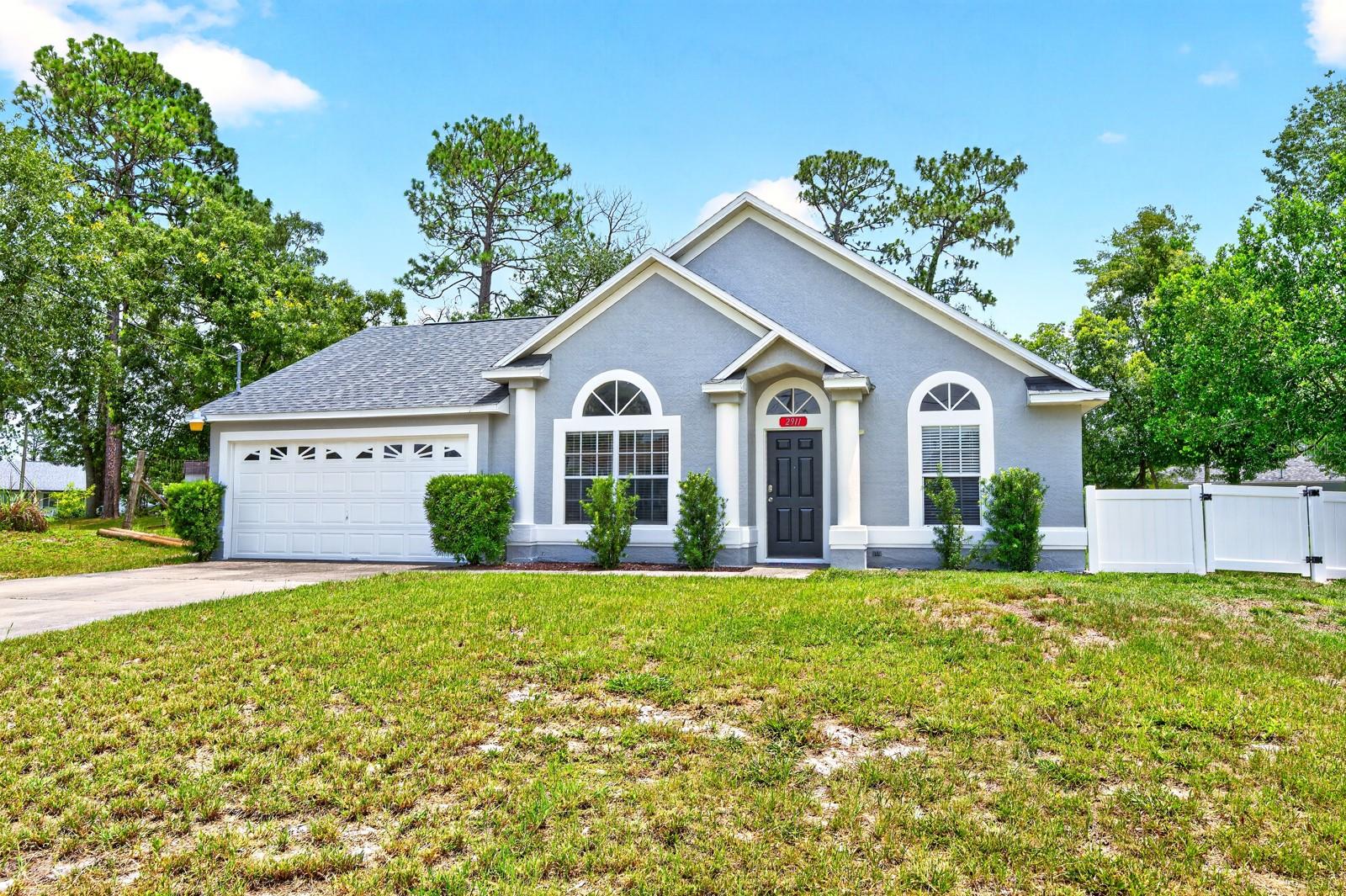 Fresh updates, a NEWER ROOF (2022), and a sprawling .41 ACRE ~ FULLY FENCED LOT with NO HOA make this Deltona Lakes home an opportunity you won't want to miss! Recent improvements include FRONT EXTERIOR PAINT (2026), a NEW VINYL GATE (2026), FRESH INTERIOR PAINT IN THE BEDROOMS (2025) and a SEPTIC SERVICE (2025), plus a RESFRESHED GUEST BATH (2024). Perfectly situated in an established community, this 3-bedroom, 2-bath single-story home offers the space, privacy, and flexibility you want, with an easy commute to Orlando via I-4 and quick access to Lake Helen Osteen Road and Howland Blvd. The surrounding area continues to grow with new shopping, dining, retail, and coffee shops just minutes away. The interior of the home delivers VAULTED CEILINGS in the living area and all three bedrooms creating an open, airy feel, while additional recessed lighting enhances the bright, welcoming living space. The SPLIT BEDROOM FLOOR PLAN provides ideal privacy, and the EAT-IN KITCHEN is designed for everyday living with STAINLESS STEEL APPLIANCES, pantry storage, a neutral color palette, abundant NATURAL LIGHT, and a convenient pass-through to the living area to keep everyone connected. Your PRIMARY SUITE serves as a relaxing retreat with vaulted ceilings, a WALK-IN CLOSET, and a well-appointed en-suite bath featuring ample storage, a tiled shower, and a separate soaking tub. Two additional bedrooms and the updated guest bath provide comfortable accommodations for family or guests. Sliding glass doors open to the true highlight of the property – an expansive fully fenced backyard surrounded by mature trees. Cleared and ready for your vision, the oversized .41-acre lot offers endless possibilities with plenty of room to add a pool, create an outdoor entertaining space, store your toys, or simply enjoy the peaceful tree-lined setting. With carpets that were just professionally cleaned, an updated roof, water heater, and A/C, NO HOA, and room to grow both inside and out, this Deltona Lakes home is ready and waiting for you to make it yours. Call today to schedule a tour!