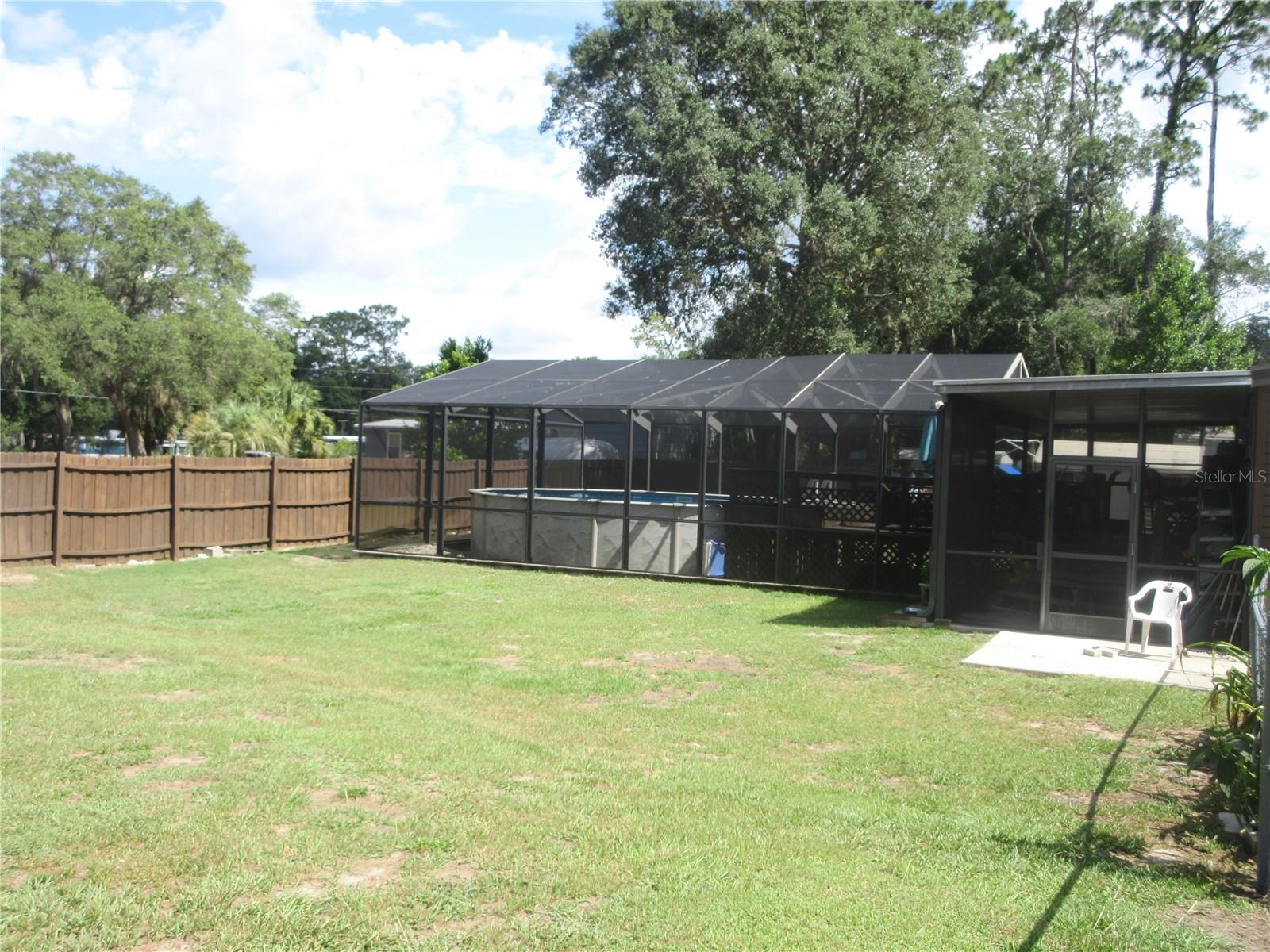 AFFORDABLE BIG LAKE ACCESS POOL HOME LOCATED IN THE FAMOUS OCALA NATIONAL FOREST! Come see this neat and clean recently remodeled 1984 3/2 doublewide mobile home situated on a gorgeous .32 acre paved road lot just 200 feet away from the community boat ramp which gives you direct accress to 400 Acre, North Lake, with some of the Best Big Bass fishing, kayacking, skiing and boating anywhere in the state of Florida! Ourtside features a spectacular and refreshing 24 foot x 4 1/2 foot deep screened enclosed pool with party deck and covered patio for your well deserved down time. Outside also features a breezy front porch, handy carport and an 8x12 shed. The back yard is chainlink fenced-in for your faithful children and pets safety. Also efficient double pane horizontal slider windows were installed in 2020, 2017 shingle roof, 2021 vinyl siding, stucco underskirting, above ground electric and sidewalk, 2019 central A/C Heat pump and duct work. Plus ALL NEW PLUMBING through out in 2023. Inside features textured walls, a spacious 11x22 living room with a romantic wood burning brick fireplace with blower, 2002 laminate flooring, ceiling fans, 2021 water heater, 3 large walk in closets and a gorgeous eat in kitchen with a large counter space for you to perform all of your amazing cooking skills! The guest bath includes a tub/shower and the master bedroom features a relaxing garden tub! Sale includes an arm chair, book case, desk, 2 chest of drawers, fan, dining table & 4 chairs, 4 bar stools, couch, rocker, recliner, dresser & mirror, lamp table, range, refrigerator, washer, dryer, fan, 4 captain chairs, 4 patio chairs, ceiling fans and all window dressings. You get it all for a low AFFORDABLE PRICE of just $159,900! Hurry!!!  Home is located in the Ocala National Forest which affords you almost a ½ million acres of Forest to roam, 600 lakes, 2 rivers, Juniper Springs, Silver Glen Springs, Salt Springs, Swimming, Skiing, Big BASS Fishing, Boating, Camping, Hiking, Horse back riding and some of the best ATV riding anywhere. Daytona Beach is just 1 hour away. Let the fun begin! You need it!
