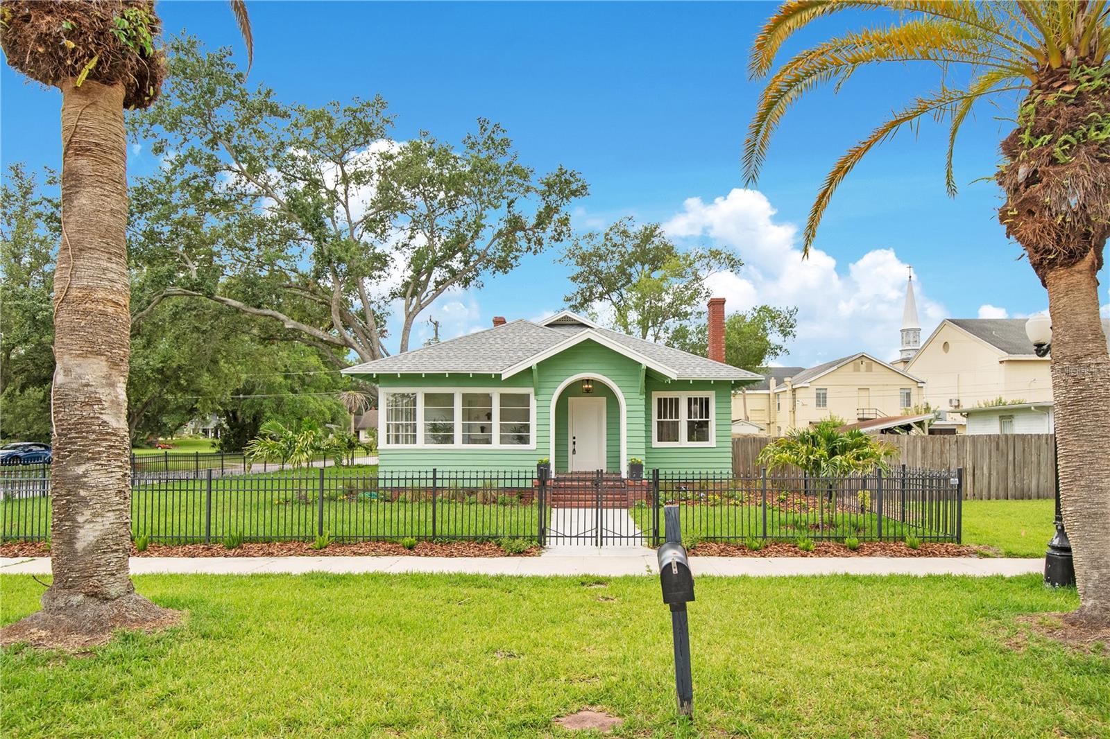 Step into a rare piece of Sanford history with this beautifully restored century-old home, prominently located at the gateway to the Historic District on iconic South Park Avenue. This large 3-bedroom, 2-bath residence offers nearly 1,900 square feet plus a spacious private-entry office. From the moment you arrive, the charming wrought-iron fenced yard and brand-new brick-paver driveway set the tone for what’s inside. This home has been restored -not simply renovated- striving to honor its original craftsmanship and preserve its soul. Inside, you’ll find restored original hardwood floors, red mosaic tile in office, authentic period paint colors, and original working windows complete with their historic weights and ropes—a true testament to the care taken in bringing this home back to its former glory. The fully updated kitchen and bathrooms seamlessly blend modern luxury with historic elegance, featuring upscale finishes, designer touches, and stunning chandeliers throughout. The cozy wood burning fireplace anchors the living space, adding warmth and character.  This home is zoned residential/commercial, which offers incredible flexibility for a home-based business, studio, or professional office while still enjoying all the warmth and charm of historic living. Brand new: AC, brick paver driveway/patio area, fresh paint inside and out all new fixtures are just a few items on the long list of recent improvements!  Located in highly desirable Downtown Sanford’s historic golf cart district, you’re just minutes from award-winning restaurants, breweries, shopping, entertainment, and the city’s famous festivals and events. Whether you're looking for a distinctive residence, an investment opportunity, or the perfect live/work space, this one-of-a-kind historic gem delivers charm, flexibility, and location in one unforgettable package. Schedule your showing before it's gone!