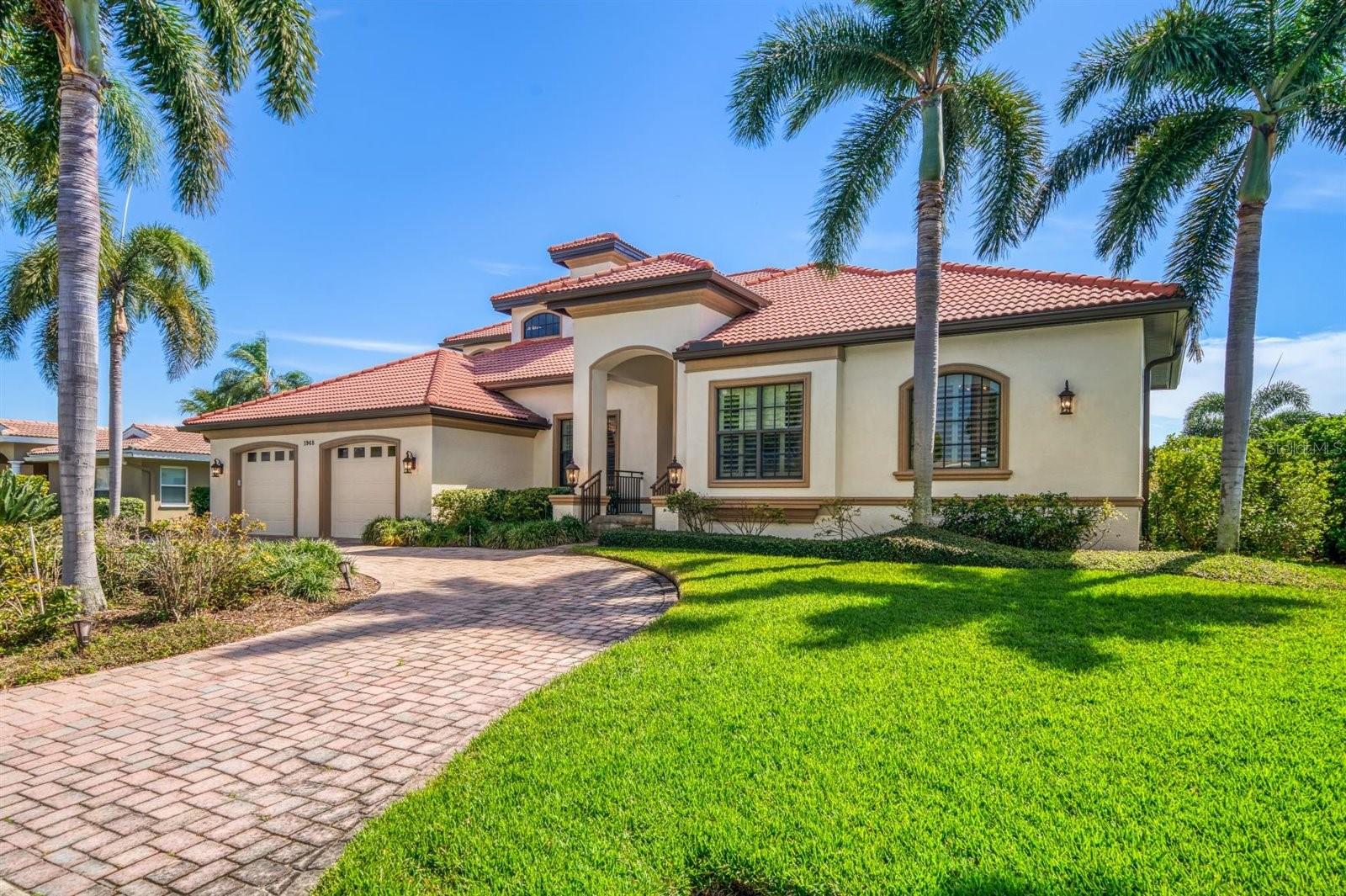 This Waterfront Home is located in the community of Venetian Isle. Southern Comfort is built into the design of this Custom home. The pavered circular drive sets the ambience of the many tasteful details. Welcome, step through the beautiful double doors of wood, glass and iron decorations into the entry hall. The living room and dining room with wood floors, high ceilings and crown molding are open for entertainment. Entrance to the left leads to the magnificent kitchen with prep island and an extravagant granite counter top for sitting or serving. Also offers a walk in pantry and a full laundry room with more storage cabinets. This great room includes a dinette area, a wet bar with Icemaker and leaded glass display cabinets. The entire rear wall is finished with stunning wood cabinets and shelves to hold the entertainment electronics. The half/bath is not only convenient but lovely with special lighting and details. The Spacious Master Bedroom Wing with ensuite offers two walk in closets, double vanities a large, glass enclosed shower, a separate soaking tub, a bidet and toilet. Each room on the first floor allows access to the rear porch, Outdoor Kitchen, Pool and Dock. Take the stairs or ELEVATOR to the second floor. A morning kitchen with built in cabinet, microwave and refrigerator is located in the hall. There is a Second Master with ensuite. Two more spacious bedrooms share a full bath. Both bedrooms have access to the Covered Verandah with spectacular Waterviews.