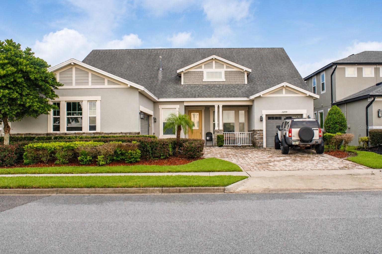 Virtually Staged. Welcome to 14779 McClane Road!

 Set behind the gates of Oxford Chase, this one of a kind Mattamy home stands apart from anything else in the community. Five bedrooms, four baths, and 3,118 square feet of genuinely upgraded living on a lot that simply cannot be replicated. At the heart of it is a custom designed kitchen any chef would love to call their own. A dramatic waterfall edge stone island seats four beneath designer glass pendants, surrounded by crisp white cabinetry, a deep stainless farmhouse apron sink, a gas cooktop beneath a vented stainless chimney hood, and a full stainless double wall oven. It opens directly into the great room and flows to a formal dining room crowned by a tray ceiling, bay window, and cascading crystal chandelier. Large stone look tile runs continuously through every common area with no transitions and no compromises.

 The attention to detail carries throughout. Every bathroom features tile taken floor to ceiling in the shower surrounds, accented by a custom glass mosaic inlay band. The first floor primary offers privacy and generous proportions, while a main floor laundry room adds a deep storage closet, the kind of everyday storage that makes a home genuinely functional.

 Upstairs is where this floor plan gets extremely special. A spacious loft paired with its own full bathroom creates a genuine second living quarters, not a bonus room with a powder bath down the hall. Aging parents get real independence. Young adults returning home get privacy and dignity. An au pair, a long term guest, or a live in caregiver has a complete suite of their own. It is the kind of true multi generational layout families search for and rarely find.

An oversized 3 car garage with an extra deep bay handles the vehicles, the workshop, and everything in between.
Step outside and the setting speaks for itself. An oversized covered lanai opens onto a wide, open lawn with no rear neighbors and no homes across the way. The protected retention area means that openness is permanent, not a temporary view waiting to be built out. The yard is already pre wired for a pool, so your private resort is ready whenever you are. A walking trail sits just a short stroll from your door. And nearly every night, you can finish dinner on the lanai and watch Disney's fireworks light up the sky, visible from multiple vantage points throughout the home.

The location may be the quietest luxury of all. SunRidge Elementary and SunRidge Middle are an easy walk from your front door. AdventHealth Winter Garden sits roughly five minutes away. Minutes in the other direction, the new $31 million Tucker Ranch wellness complex is bringing a teaching farm, botanical gardens, retreat center, and fitness trail system, joining the existing 200 acre nature preserve on Johns Lake with its kayak launch and miles of trails. Plant Street's restaurants and award winning Farmers Market, Winter Garden Village, and quick access to the 429 are all close at hand, with Orlando International Airport about 30 minutes out.
Homes in Oxford Chase rarely come available, and lots like this one almost never do. 

Schedule your private showing today!