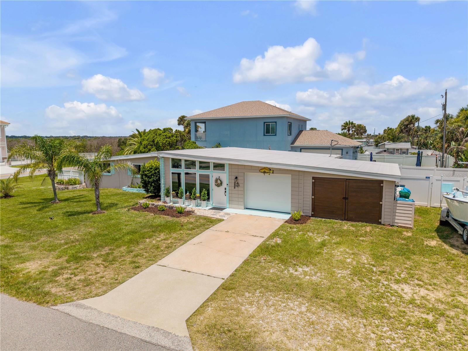 Beachside living starts here in Wilbur-by-the-Sea, just three blocks from the Atlantic Ocean. This 3-bedroom, 2-bath mid-century beach home sits on an oversized no-HOA corner lot with room for your boat, RV, golf cart, and beach toys.

Inside, enjoy bright open living spaces with volume ceilings, wall-to-wall windows, and a covered patio perfect for relaxing or entertaining after a day at the beach. The primary suite offers a private patio entrance, giving you added flexibility for guests or a potential in-law setup.

Major updates include a new roof, soffit, fascia, and gutters in 2025, new fence in 2024, new windows and doors in 2023, A/C in 2020, and septic pumped in 2026.

With an attached garage, boat house/workshop, and room to expand, this home offers space, updates, and location all in one. Walk to the no-drive beach, enjoy ocean sunrises, and launch nearby at Wilbur Boat House — this is the coastal lifestyle buyers are looking for.