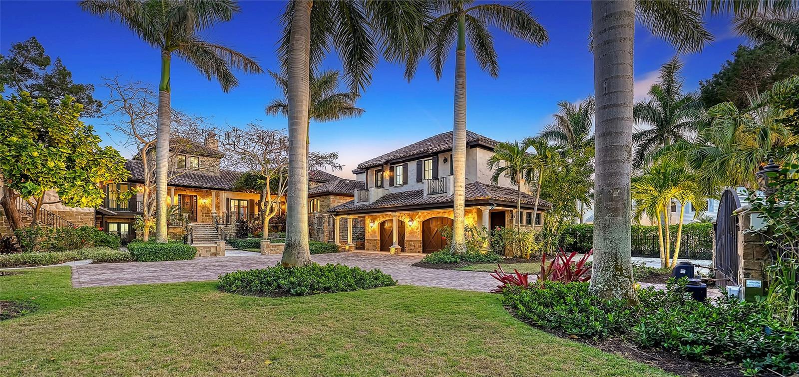 OVER HALF A MILLION DOLLAR PRICE REDUCTION!! A stunningly beautiful custom home in the very best of locations in coveted Cedar Park Circle on north Siesta Key. A short walk or bike ride to famed Siesta Beach and fun, eclectic Siesta Village, minutes by car or boat to mainland Sarasota and the Gulf of Mexico. This fabulous property affords awe inspiring views of Cocoanut Bayou and Robert's Bay. A rare find, this very private, fenced and gated property boasts over 220 waterfront feet on the bay and includes 150 feet of dockage complete with a new 20k pound lift, 2 jet ski lifts, plus a cut-in sea-walled dock to accommodate a 50' vessel. Two expansive levels with soaring ceilings provide both formal and casual living spaces. The front entrance to the home features an arbored patio, ideal for welcoming guests with cocktails and hors d'oeuvres. Enter the stone-faced home through an impressive wood and iron door into the foyer/sitting room overlooking the pool and bay. Just to the right is a massive great room with oversized stone gas-fireplace, french doors, beamed ceilings, chandeliers, and the expansive dining room with custom built-ins just beyond. Around the corner, enter your newly and exquisitely renovated den/kitchen/nook area with views to the Bay/bayou. All of the best finishes and fixtures make this area your perfect private retreat. The gourmet kitchen features white on white cabinets and quartz countertops, an 8 burner Wolfe gas cooktop, two SubZero refrigerator/freezers, and a built-in Miele coffee system. The custom built-ins in the den area subtly contain a myriad of conveniences including second dishwasher and refrigerator. This home is a dream for entertaining. Virtually every room has an outdoor balcony. The expansive back terrace with newly tiled travertine features a summer kitchen, fire pit, reclining areas, covered dining area, and salt water infinity pool. Just steps away, board your boat or jet skis for a jaunt on the water. The home's private quarters provide infinite serenity. The exquisite master suite comes complete with separate his and her baths and closets. The exercise room, home office and outdoor tiled deck are just steps away in the private master wing. At the opposite side of the home, three sumptuous bedrooms with private balconies and baths provide a wonderful retreat for family and guests. The ground floor grotto/media room with full bar, wine room, 5th bedroom, steam bath, and two outdoor patios is the ideal guest haven. Two laundries - one on each wing of the home, an oversized two car garage with built-in storage, parking pad and abundant parking space within the compound, and under-house storage, all add to this incredible home. Additional appointments include designer outdoor landscape lighting, 4 zone heating/cooling, impact windows and doors, and so much more. This community affords beach access just across the street at the Cocoanut Bayou private beach!