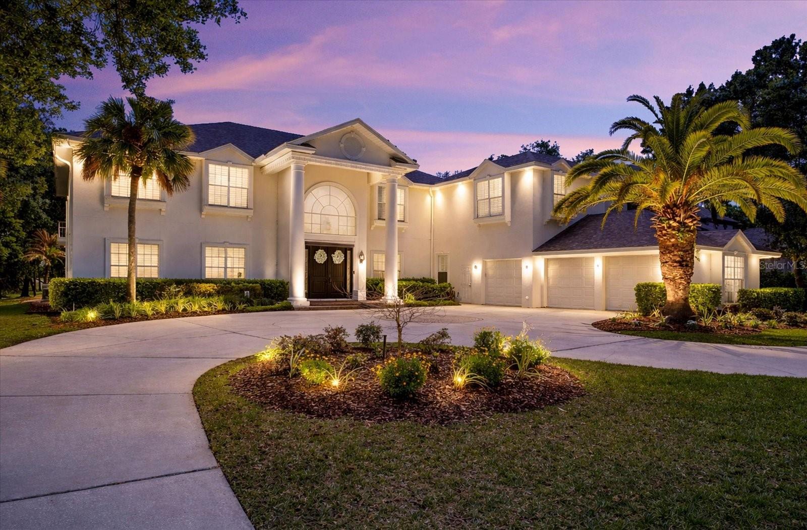 One or more photo(s) has been virtually staged. HUGE PRICE REDUCTION!!  SELLERS MOTIVATED!  This stunning estate blends timeless elegance with modern luxury, set along the 8th fairway of the Tampa Palms Golf & Country Club. Located in The Reserve, one of Tampa Bay’s most exclusive guard-gated communities, it spans over 7,700 square feet and has been transformed by a recent $500,000 renovation. The soaring two-story living room offers panoramic views of conservation land, sparkling water, and the manicured golf course, while rich handscraped hardwood floors and designer finishes add warmth and style throughout. The gourmet kitchen features Calacatta Bianco quartz, custom cabinetry, Sub-Zero and Thermador appliances, whole house water filtration, including reverse osmosis in the kitchen, 2 tankless water heaters and impact windows throughout,  plus a walk-in pantry and built-in workstation—perfect for both everyday meals and entertaining. Five spacious bedrooms each have their own ensuite bath, with the primary suite opening to a private lanai and sun terrace, and a spa-like bath with a freestanding tub and dual walk-in closets, one doubling as a nursery or retreat. Outside, a screened lanai frames the resort-style pool and spa, alongside an outdoor kitchen with an Alfresco grill, sink, and beverage fridge, all overlooking serene conservation and golf views. Additional highlights include a custom third-floor theater, dedicated office, billiards room, and thoughtful upgrades throughout.