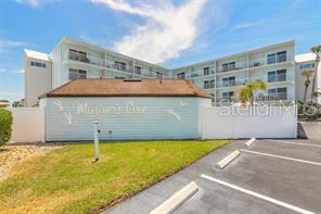 Studio Condominium is steps away from the beach in New Smyrna Beach - Your Slice of Paradise Awaits! Wake up to the sound sight of seagulls gliding above the surf, and the feeling of soft sand beneath your feet. This charming ocean-view studio is more than just a home. It's a lifestyle. Nestled in the heart of New Smyrna Beach, it's the perfect blend of comfort, convenience, and coastal charm. Enjoy peaceful morning walks on the beach, unwind by the sparkling community pool, and savor sunsets from your own private haven. Located in a well-maintained, quiet condo community with low maintenance fees...the lowest in the area! Plus, you're in a non-flood zone, with all walkways, balconies, elevators recently redone during their $2,000,000.00 renovation and assessments paid. This thoughtfully designed studio features a brand new space-saving King Size Murphy Bed to maximize your living area, and a Queen Size Sofa Bed. The full kitchen has just been completely remodeled with new cabinets, lighting and appliances.  Brand new closet doors and popcorn ceiling removed and replaced with smooth attractive texture, brand new paint throughout. Move in Ready. Private Parking Included. Steps from top rated restaurants, boutique shopping and all the local fun and color NSB is known for. Property has an elevator and secure mailroom, and you are right on the dividing line of drive or no drive beach.  Call to schedule your showing of this Immaculate Beach Property.