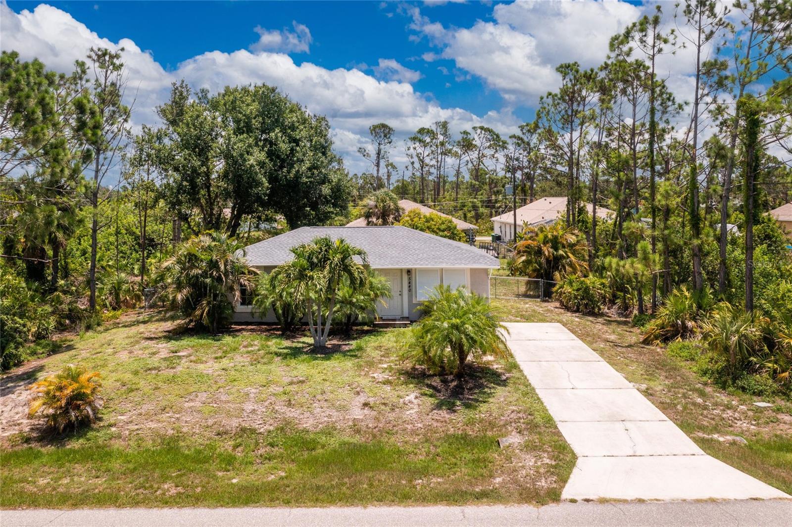 Buyer's financing fell through and their loss is YOUR gain! This charming Florida cottage has been beautifully updated and is move-in ready! Mature Florida landscaping provides privacy to the front of the home as you approach the front door. Enter into a cozy living room, full of natural light and you will instantly feel at home. Approaching the kitchen to the back of the home you'll see a hallway leading to the home's three bedrooms, one of which is a fully private master suite, and guest bathroom. Continuing forward you will find the kitchen fully outfitted with stainless steel appliances and an over-the-sink window. Combined with the sliding glass doors, the amount of natural light filling this home is breathtaking and gives the living space a bright and breezy feel. Through the sliders you will find a spacious and fully-fenced backyard with shade trees throughout. This property is being sold turnkey furnished, so all you need to bring is your suitcase! The roof was redone in May 2023 and the home features luxury vinyl laminate throughout for easy cleaning. New septic tank to be installed by the end of September. Located in Gulf Cove new owners can take advantage of an optional HOA to access the community boat ramp, but enjoy no community restrictions. Within close proximity to sparkling Gulf beaches, multiple golf courses, shopping and dining, and multiple entertainment venues residents are in for fun at home or away. Cute as a button and ready to go, this home won't last long so call now for your private showing!