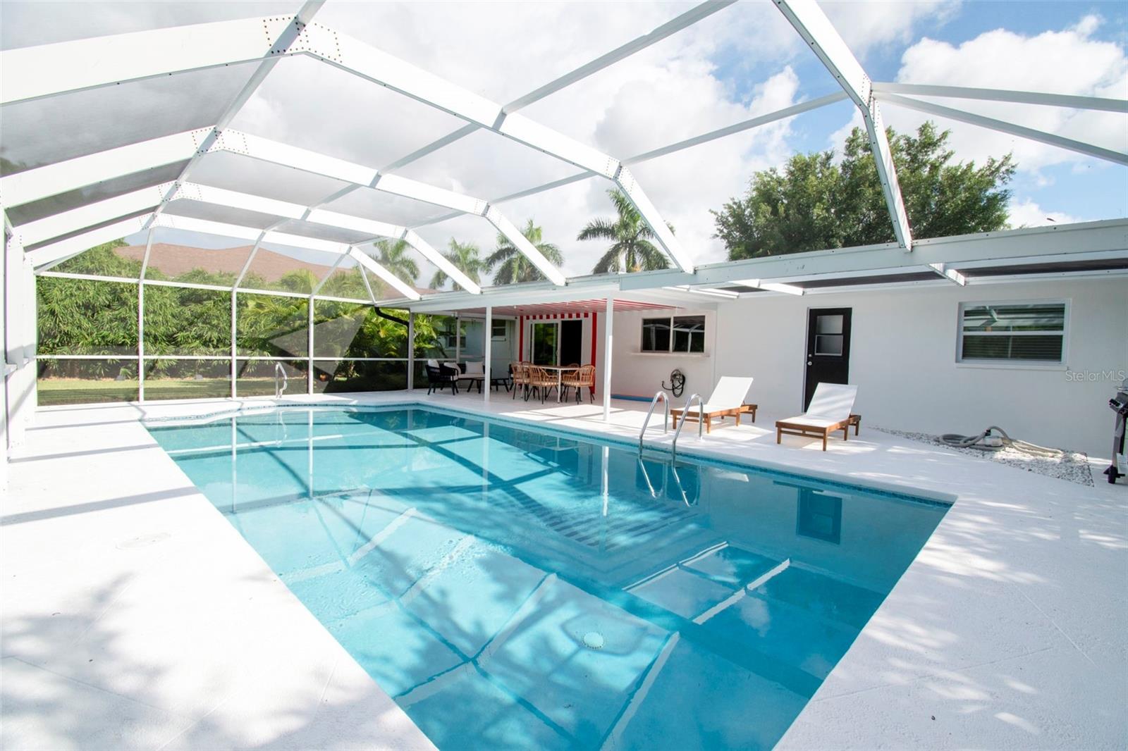 Welcome to 59 Wickliffe Drive, a beautifully maintained pool home in the highly desirable Willoughby Acres community of North Naples. Perfectly positioned on an oversized lot with no HOA fees or rental restrictions, this residence offers the flexibility of a primary residence, seasonal retreat, or income-producing investment property. Designed for the Southwest Florida lifestyle, this three-bedroom, two-bath home features an open and inviting floor plan with tile flooring throughout, creating a seamless flow between living, dining, and entertaining spaces. Step outside to your private backyard oasis where a spacious screened lanai and sparkling pool create the perfect setting for year-round outdoor living. Whether enjoying your morning coffee, hosting family gatherings, or relaxing after a day at the beach, this outdoor space was designed to be enjoyed. Recent improvements, including a newer roof in 2022 which provides peace of mind and the recently renovated bathrooms enhance the home's move-in-ready appeal. The generous lot offers ample space for pets, gardening, recreation, or future enhancements. Located in the heart of North Naples, Willoughby Acres remains one of the area's most sought-after neighborhoods due to its convenient location, A-rated school district, and lack of HOA restrictions. Residents enjoy quick access to world-class beaches, Mercato, Waterside Shops, fine dining, shopping, entertainment, golf courses, and Interstate 75. Vanderbilt Beach, Delnor-Wiggins Pass State Park, and the vibrant Naples lifestyle are all just minutes away. Whether you're searching for a full-time residence, vacation getaway, or investment opportunity, 59 Wickliffe Drive delivers the perfect combination of location, lifestyle, and value in one of Naples' most established communities.