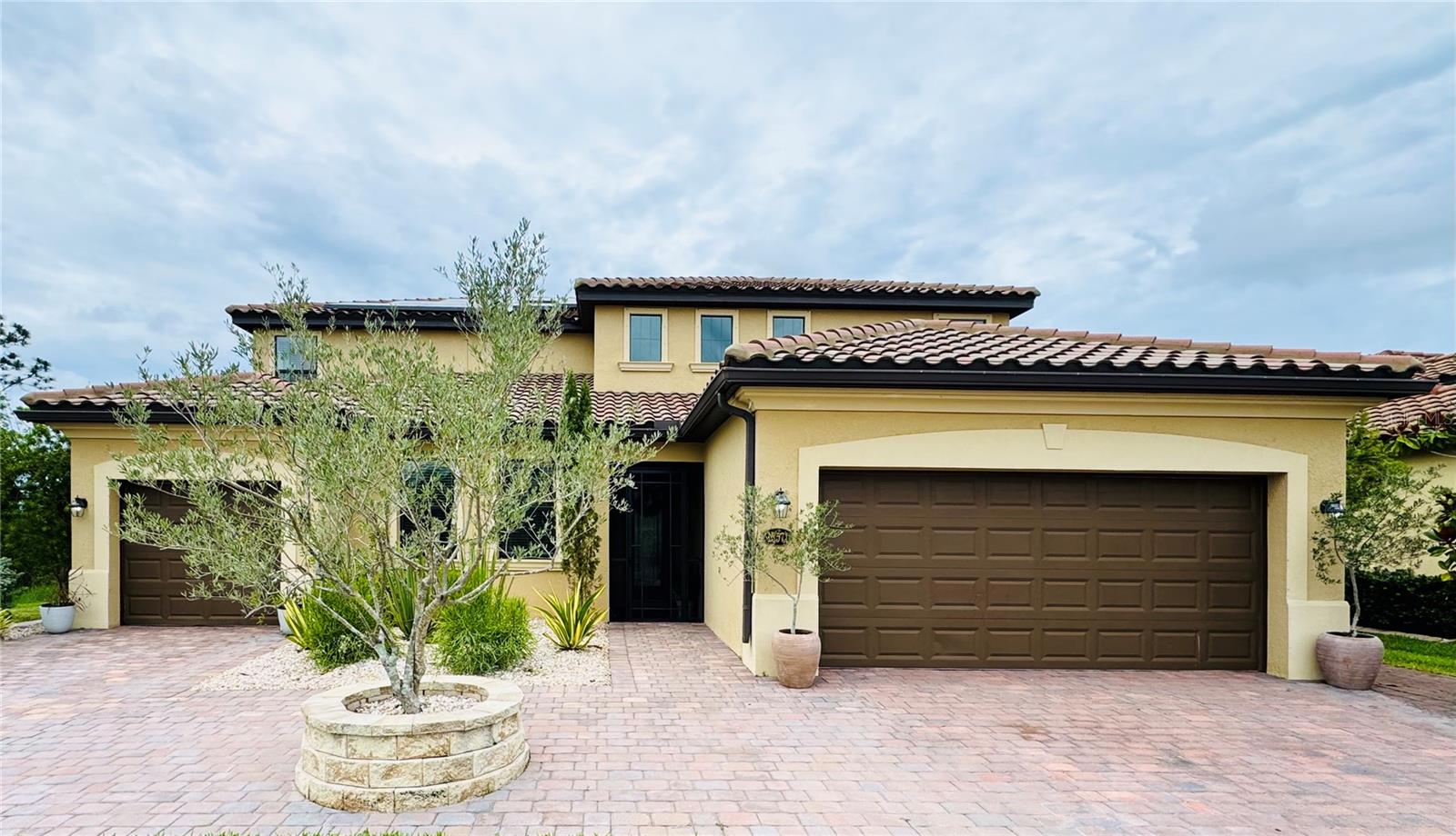 Welcome to an exceptional upgraded estate in the gated resort-style community of Gran Paradiso. This impressive Lennar Liberation model offers nearly 3,905 square feet of heated living space, a private pool, a 3-car garage configuration, preserve and pond views, and one of the most desirable layouts available: two private living residences under one roof.
Designed for flexibility, privacy, and elevated everyday living, the main residence features 5 bedrooms, 3.5 bathrooms, generous gathering spaces, and a bright open-concept layout that flows beautifully toward the pool and extended lanai. The separate Next Gen / in-law suite offers its own private entrance, living area, upgraded kitchen, bedroom, bathroom, walk-in closet, and dedicated 1-car garage — ideal for extended living, long-term guests, private workspace, or independent household needs.
The current owners have invested over $300,000 in thoughtful custom upgrades, transforming the home well beyond a standard builder model. The main kitchen has been completely redesigned with premium finishes, new countertops, custom cabinetry elements, and new GE Café appliances. The in-law suite kitchen has also been upgraded with a new island and enhanced finishes, creating a refined and functional second living space.
Every bathroom has been remodeled with elegant finishes, including Venetian plaster details and an upgraded primary bath layout with Italian-style design elements. Additional interior improvements include new flooring throughout, premium carpet, fresh interior paint, new interior doors and trim, upgraded hardware, and recessed can lighting throughout the home.
Efficiency and modern convenience have also been prioritized with a Tesla solar system, EV charger, new pool heater, and a new water heater with heat boost technology. Outside, the home offers upscale professional landscaping around the entire property, a widened driveway for improved access and curb appeal, and a private lanai overlooking the pool, preserve, and pond.
Gran Paradiso is known for its Tuscan-inspired architecture and resort-style amenities, including a clubhouse, fitness center, resort pool and spa, tennis, pickleball, game rooms, billiards, walking and fitness trails, locker rooms, sauna, and steam rooms. The location places you near Wellen Park, CoolToday Park, shopping, dining, beaches, golf, medical services, and convenient access to I-75.
This is not just another large home in Gran Paradiso. It is a highly upgraded, flexible luxury residence offering space, privacy, energy-conscious features, and a rare dual-living layout in one of Venice’s most recognized gated communities.