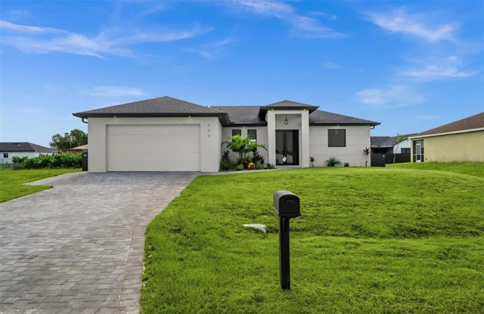 "Motivated Seller" Welcome to the "Moonstone" Model. This amazing home is the perfect blend of value, comfort, luxury, style, and security. This beautiful new construction is built for everyone who wants to live with all the comforts of 'home.’ Impact windows and doors, European style kitchen featuring soft closing cabinet doors, drawers and high-end appliances, and much more. Master bedroom with custom designed built in walk-in closet, master bath with glass shower enclosure, double vanity, and linen closet. Two spacious bedrooms with walk-in closets, guest bathroom with glass shower enclosure. Home offers open concept layout with 10-foot-high interior ceilings and designer doors. Outdoor kitchen with marble countertops and 1/2 bath by the pool, ready for enjoyment 12' x 24' beautiful pool with Sun Ledge, 2 car garage, washer, dryer, and laundry sink. "NO FLOOD INSURANCE NEEDED". Engulf in the multitude of upscale details that you must see to appreciate. Enjoy your day by the pool or explore everything Cape Coral has to offer. Do not miss out on this one-of-a-kind opportunity! Schedule your showing today and make this beauty your home!