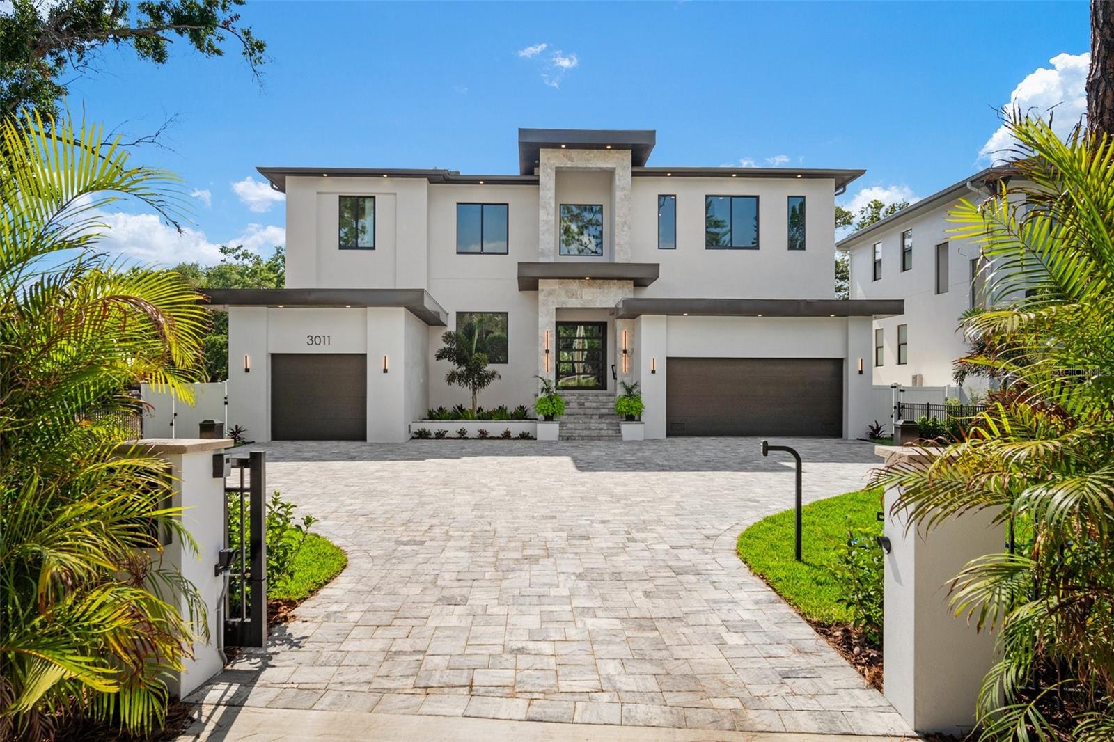 Now Ready!  Stunning new luxury home with four car garage, private gate and fabulous pool/spa situated on a very large lot in Sunset Park.  
A rare find in South Tampa – large .38 acre lot allows for large front yard with private motorized entrance gate and large paver motor court, as well as, deep backyard with outdoor Kitchen, gorgeous Pool featuring sunshelf & infinity edge Spa, LED lights, gas heater & salt chlorinator.  
The 5,297 square foot home with over 7,200 square feet under roof has an open floor plan with beautiful modern styling.  There are a total of five bedrooms all with en-suite bathrooms and two half-baths.  
Focal point of the home is a modern metal staircase with thick wood treads with dramatic free-form lighting.   Great Room has faux-finished accent wall with built-in shelving and large four panel 16’ sliders and large Kitchen with walk-in Working Pantry and Wolf/Subzero/Bosch appliances, custom wood cabinetry and quartz counters, backsplash and waterfall edges.  Dining area is open to the custom LED and glass Wine Closet and Wet Bar with ample storage and beverage refrigerator tower.   A beautiful First Floor Master/Guest Suite includes large walk-in closet and private bathroom with lovely floor to ceiling tile, pendant lighting and LED mirror.  Also downstairs is a tray ceiling in the Foyer, a large bright Office, Powder Bath, and the Mud Room includes connections for refrigerator and washer/dryer.

Upstairs are three more bedrooms – all with private bathrooms and walk-in closets – plus the Primary Suite which features LED tray ceiling, dual walk-in closets with custom built-in shelving including glass front display units and hampers and a large luxurious bright Master Bathroom with large format tile, dual vanities with motion detection LED toe-kick lighting and accented by wall sconce lights, a freestanding tub set by a large picture window and a big glass enclosed shower with multiple shower heads and a bench, a separate toilet room.

The Bonus Room has an LED accented cloud ceiling feature, impressive Wet Bar with floating shelf and tiled backsplash and a half bath.

On the rear Lanai is custom Outdoor Kitchen with stainless steel grill, hood, beverage fridge, and accessories and featuring a beautiful natural stone counter with bar seating and tile backsplash.  Large oak and lush landscaping provide privacy and a beautiful setting.

Many quality features from an experienced South Tampa builder - block construction, spray insulation for reduced energy costs, large attic storage area with pull down stairs 11’ 4” and 10’ ceilings, beautiful wood flooring, modern trim and doors, ample recessed can lights, premium lighting and plumbing fixtures, pre-wiring for many data, security and audio/visual options including wall-mount televisions, cameras, speakers and automation.