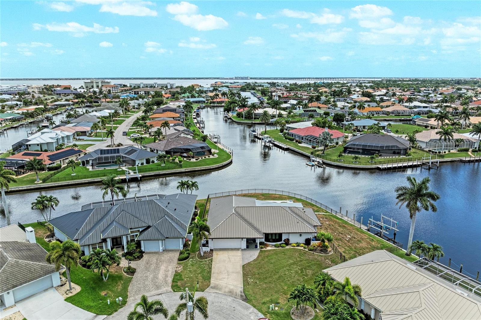 Luxury Waterfront Living at Its Finest! Every detail of this spectacular, fully remodeled waterfront pool home has been thoughtfully designed with high-end finishes and timeless style. Situated on an incredible tip lot with 184 feet of city-maintained concrete seawall, this property offers panoramic intersecting saltwater canal views and exceptional boating access with a quick boat ride to Charlotte Harbor and beyond. This home had NO flooding during any storms. 

Step inside to discover designer-selected finishes, luxury vinyl plank and porcelain tile flooring throughout, and a stunning chef's kitchen featuring a massive quartz island, abundant custom cabinetry, and an open layout perfect for entertaining. The beautifully remodeled bathrooms showcase floor-to-ceiling porcelain tile, creating a true spa-like experience, while spacious walk-in closets provide ample storage. Home was taken down to the studs and remodeled in 2023. A complete change to the layout and all surfaces fully renewed including new plumbing! 
Enjoy Florida living year-round with a heated pool and spa overlooking the water, a private dock with a 10,000-pound boat lift, and an expansive fenced backyard enclosed with an elegant black aluminum fence. Additional features include NEW METAL ROOF, impact-resistant windows and doors throughout, upgraded electric panel and a spacious two-car garage.

This is a rare opportunity to own a move-in-ready waterfront masterpiece where luxury, style, and boating come together in one exceptional property.