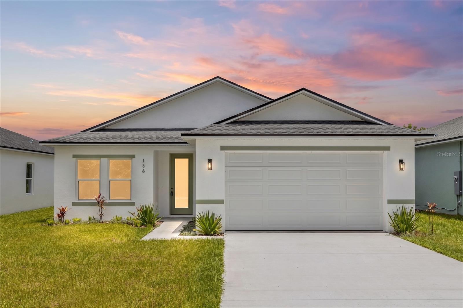 **THIS HOME QUALIFIES FOR AN INTEREST RATE AS LOW AS 5.5% WITH A POTENTIAL MONTHLY SAVINGS OF UP TO $232/MTH** Welcome to your BRAND-NEW lakeview dream home overlooking beautiful Lake Eulalia! Perfectly positioned on a quiet street, this stunning new construction offers the ideal blend of modern luxury, thoughtful design, and peaceful waterfront living. Inside, you'll find an open-concept split floor plan with soaring 9'4" ceilings, luxury vinyl plank flooring throughout, recessed (canned) lighting, and an abundance of natural light pouring through the impressive 8-foot glass front door with built-in blinds and oversized 8-foot sliding glass doors. The versatile flex space is perfect for a home office, formal dining room, playroom, or even a potential fourth bedroom to fit your lifestyle. The designer kitchen is the true centerpiece of the home, featuring elegant quartz countertops, a striking sage green island, matching sage green subway tile backsplash, soft-close cabinetry and drawers, stainless steel Whirlpool appliances, Kraus fixtures, a spacious walk-in pantry, and a large single-basin sink—creating the perfect space for cooking and entertaining. Retreat to the private primary suite overlooking Lake Eulalia, complete with two spacious walk-in closets, a spa-inspired ensuite featuring dual vanities, and beautifully appointed finishes. Additional storage throughout the home includes both a linen closet and coat closet, providing convenience and functionality. Step outside to your backyard overlooking the lake, where endless possibilities await. Create your dream outdoor oasis with a fire pit, lakeside lounge, outdoor kitchen, or private dock to fully enjoy Florida waterfront living. Schedule your private showing today! Home may be under audio or visual surveillance.