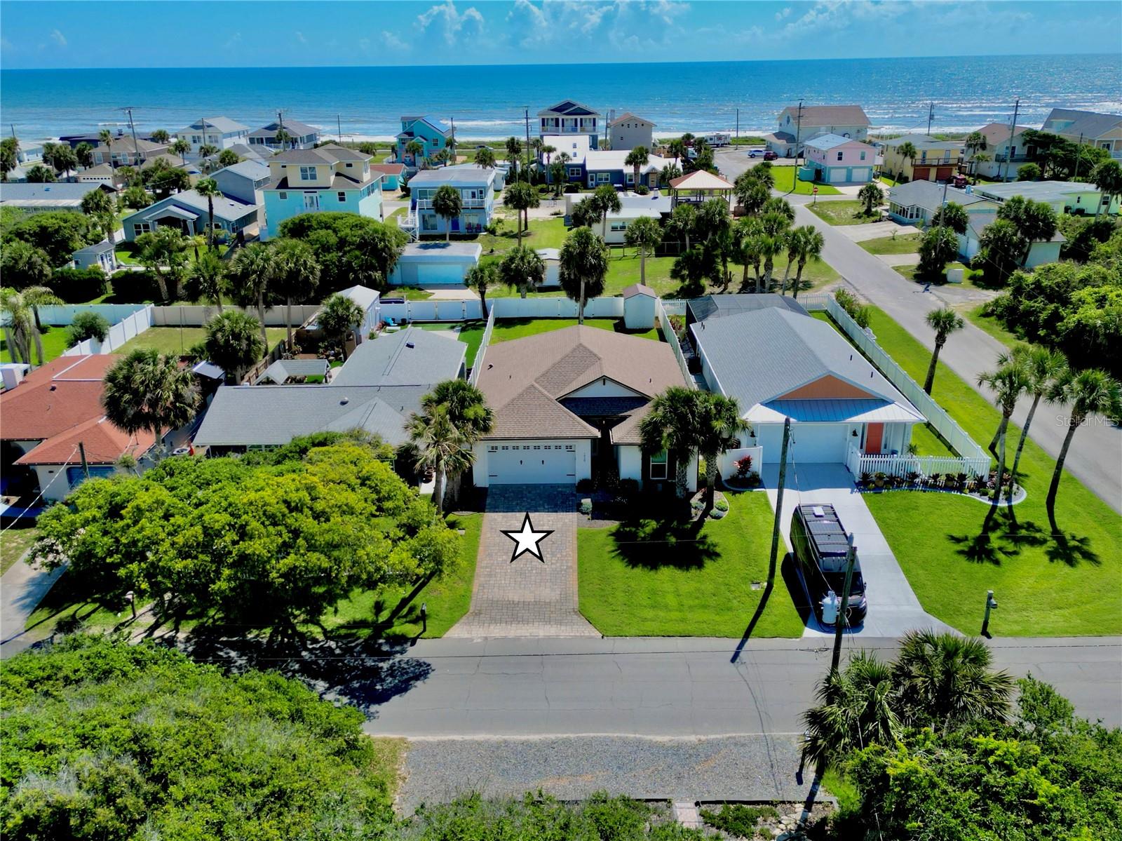 Built in 2020 and ideally located just two blocks from the ocean, this move-in ready custom 3-bedroom, 2-bath home sits on a high-and-dry lot in golf cart-friendly Flagler Beach. Enjoy a short walk to the beach along with easy access to the coastal lifestyle this area is known for.

Inside, you’ll find 10-foot ceilings, 8-foot interior doors, 6-inch baseboards, LVP flooring, tile baths, impact windows, plantation shutters, and soundproofing in the interior walls for added comfort. The beautifully designed kitchen features double-stacked cabinetry with glass uppers and lighting, granite countertops with waterfall edges, marble backsplash, propane range, convection microwave, beverage refrigerator, upgraded fixtures, and generous pantry storage with upgraded wood shelving.

The primary suite offers custom California closets, while the second bedroom includes a Murphy Bed and desk with a 25" x 80" work surface, creating the perfect flexible guest room or home office. Additional features include a whole-house on-demand generator, on-demand water heater, indoor laundry room with utility sink and Samsung washer/dryer, pull-down attic stairs with partially floored attic space, epoxy garage flooring, and an 8' garage door.

Outside, enjoy a paver driveway, full vinyl-fenced backyard with 10' gate and alley access, irrigation on a well, gutters, soffit lighting, outdoor shower with hot and cold water, 8' leaded impact front door, and an 8' x 12' storage shed with electric service. Relax on the covered patio and enjoy morning sunrises. With quality construction, coastal convenience, and a prime beachside location, this Flagler Beach home is truly a must-see.