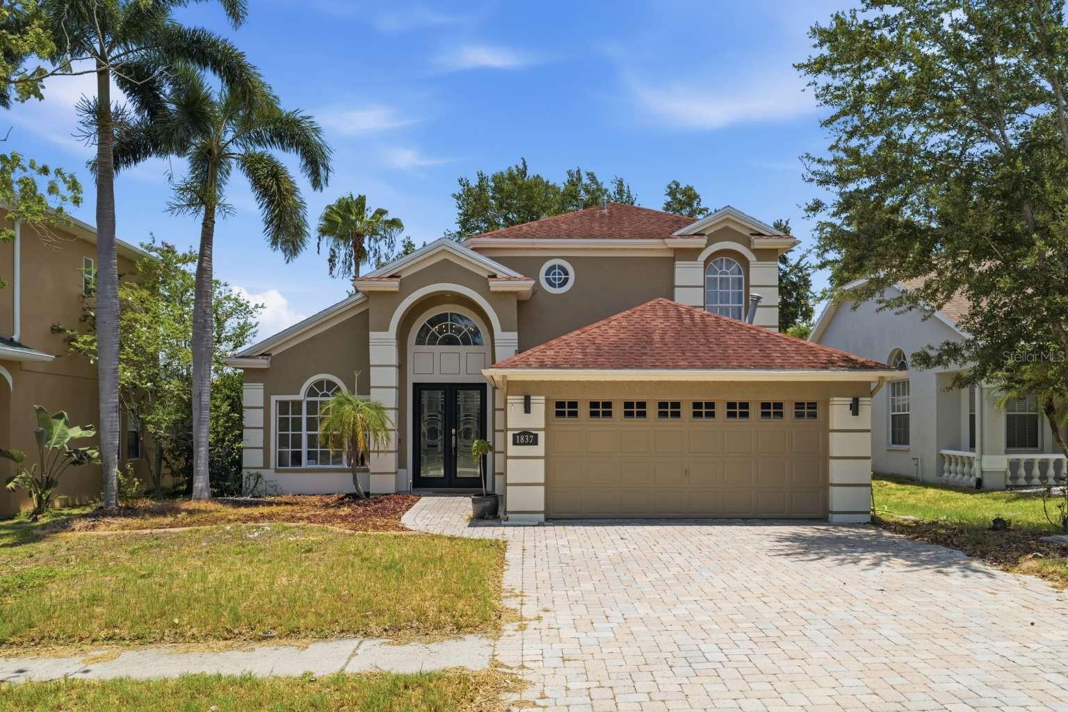 Rare opportunity in Grassy Pointe - beautifully renovated waterfront home on a quiet cul-de-sac with no rear neighbors, backing directly to a pond and natural preserve. Welcome to this 4-bedroom, 2.5-bath residence offering 2,077 square feet of comfortable living space with soaring 20-foot ceilings, abundant natural light, and peaceful pond views throughout. This home is truly move-in ready with thoughtful updates throughout. It has been freshly exterior and interior painted, creating a clean, modern, and well-maintained feel. Updated lighting fixtures and ceiling fans enhance the bright, contemporary atmosphere. The kitchen has been tastefully updated with stainless-steel appliances, including a new refrigerator and microwave. Additional upgrades include a new water filtration system and a portable generator-ready outlet, adding both convenience and peace of mind. A brand-new HVAC system (2026) provides year-round comfort and efficiency. Elegant tray ceilings, spacious bedrooms, walk-in closets in the primary suite, ample storage, and a dedicated laundry room add both style and functionality to everyday living. Step outside to the true highlight of the home - an expansive covered waterfront deck overlooking the tranquil pond. Designed for year-round enjoyment, this outdoor living space is perfect for entertaining guests, sipping your morning coffee, watching otters and turtles glide through the water, or simply unwinding in a peaceful natural setting. The home offers exceptional privacy with no rear neighbors, backing directly to a pond and natural preserve. Additional features include a cozy gas fireplace for cooler evenings, hurricane shutters, and thoughtful upgrades throughout that enhance both comfort and security. A 2-car garage provides added convenience and storage. Located in the sought-after Grassy Pointe neighborhood, this home offers the perfect blend of tranquility and convenience with easy access to the Pinellas Trail, Innisbrook Golf Resort, Fred Howard Park, Sunset Beach, and the vibrant historic Tarpon Springs Sponge Docks (Greek Town). Ideally situated just 20 minutes from Honeymoon Island State Park and within 40 minutes of Clearwater Beach, Tampa International Airport, and St. Pete-Clearwater International Airport, this residence delivers exceptional access to award-winning beaches, cultural attractions, dining, and travel. Do not miss this opportunity to own a move-in-ready waterfront home in one of Tarpon Springs' most desirable communities.