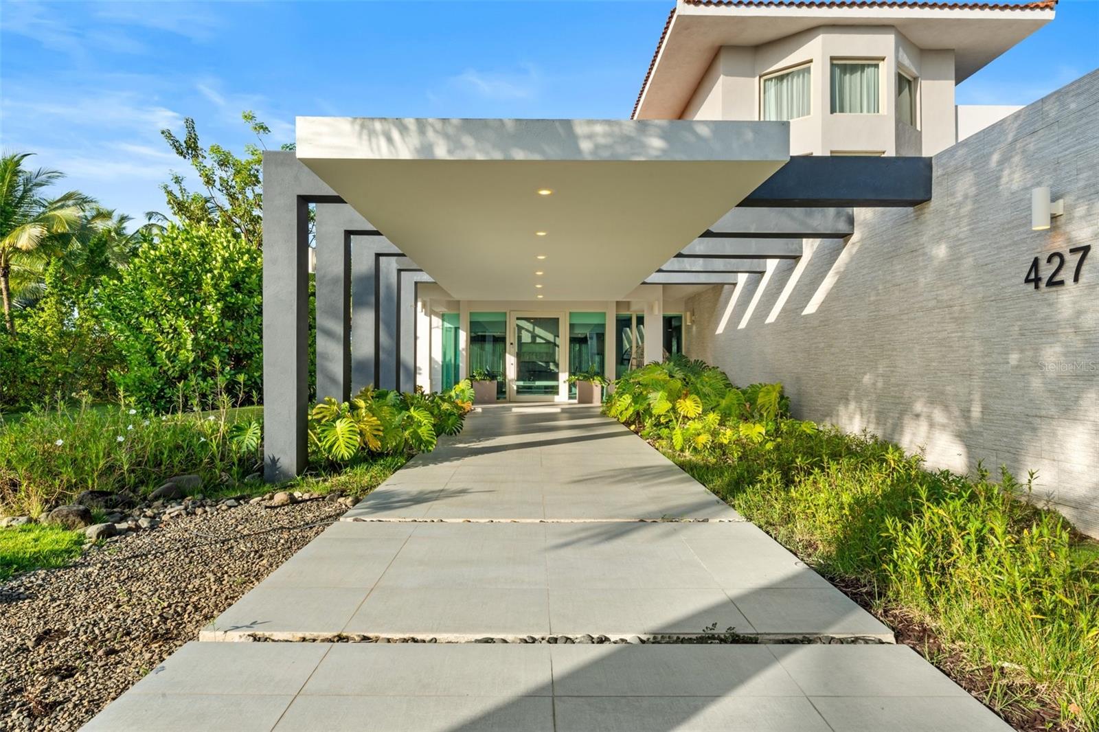 Now available at a new price! Located within the prestigious gates of Dorado Beach East, this modern and elegant multi-level residence sits on over 2,440 square meters of titled land, one of the largest lots in the community. The home features approximately 9,250 total square feet of construction, including 8,100 square feet of fully air-conditioned interior living space. Designed with style and functionality in mind, it offers 6 bedrooms, 7 full bathrooms, 1 half bath, as well as a versatile bonus room that can serve as a sixth bedroom, office, media room, or guest space. 

The third level features a private suite with a walk-in closet, en-suite bath, and access to a terrace area, with potential for conversion into additional outdoor living space. On the second floor, soaring ceilings and large windows create an airy feel, with multiple bedrooms and a show-stopping primary suite that opens to a private balcony with expansive views of the golf course and lake. The primary bath is a true retreat, featuring a soaking tub, walk-in shower, outdoor shower, double vanity, private water closet, and custom-designed his-and-hers walk-in closets.

The first floor offers an additional bedroom with a built-in closet and full bath, as well as a flexible bonus room with a bathroom conveniently located just across from it. A wine cellar, mini bar with kitchenette, and dining area with glass doors that open to the exterior provide ideal spaces for entertaining. A floating staircase adds architectural interest, and the 4-car garage provides ample storage and convenience.

Outdoors, the home’s generous lot includes a private pool overlooking the lush landscape, offering the perfect setting for relaxing or hosting. Set within a world-class golf community, the home is conveniently located near the South Gate, allowing easy access to enter and exit the neighborhood. Blending upscale finishes with open, livable spaces, this residence is ideal for both refined daily living and stylish entertaining.