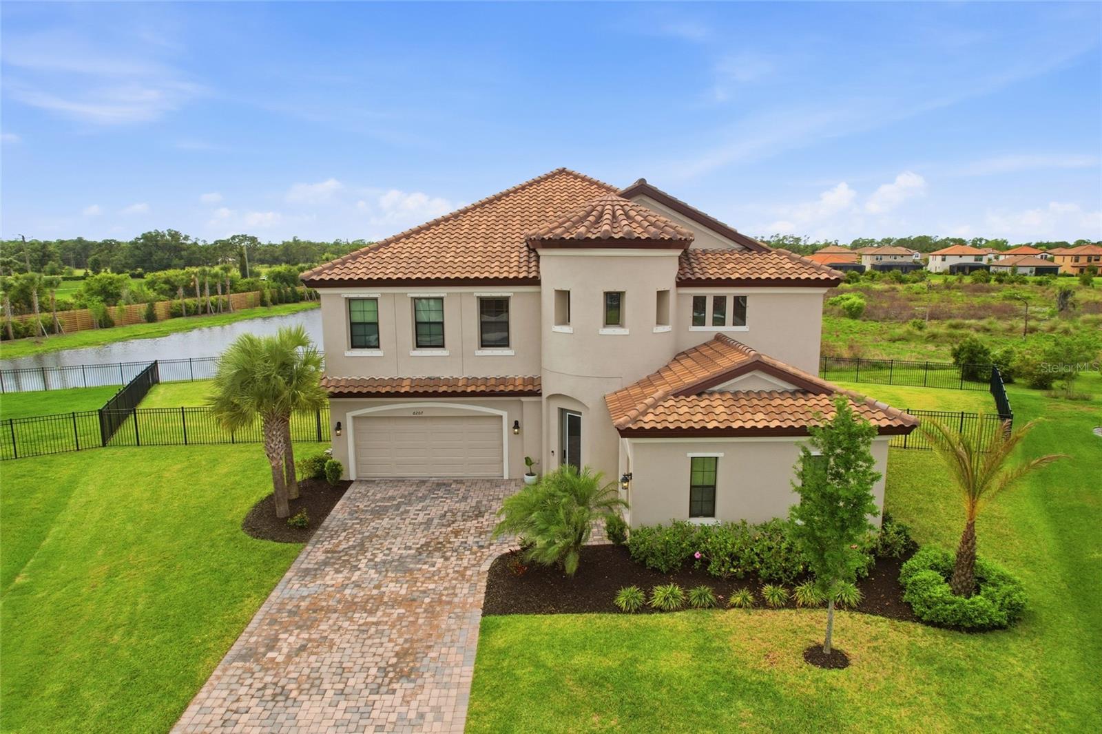 Looking for room to grow? Multi-generational living? This 2023 built WestBay home has 4,211 of living sqft and sits on over a 1/4 Acre with a private water view and fully faced yard! Wow! 3 Car garage and two oversized screened-in lanais! Located in the community of Crosswind Ranch with a LOW HOA of $45/quarter, Community Pool, 2 Dog Parks, Playground, Clubhouse and Pickleball courts! This floorplan is one of the LARGEST in the community! The First Floor provides all the common areas, 1 Bedroom with 1 Full Bathroom ideal for an In-Law/Guest Suite, Den/Office and Bonus/Flex room. The Second Floor includes the Primary Suite with attached Luxury Bathroom, 3 Secondary Bedrooms, Laundry Room, Entertaining Loft with Wet Bar and 3 Full Bathrooms! The Kitchen has GAS Cooking, a walk-in Pantry, TONS of cabinetry for storage and an expansive Kitchen Island combined with built in Dining space! Wide open Living Room with lots of natural lighting leads you to an oversized covered screened-in lanai for easy access to the backyard. Three car garage for all of your storage and vehicles with a paved driveway for additional parking. Enjoy your days lounging on your second story screened-in lanai or play in the fully fenced yard! The opportunities are endless with this home and community! Parrish is BOOMING and this home is located close to major routes, schools, shopping, dining and MORE!