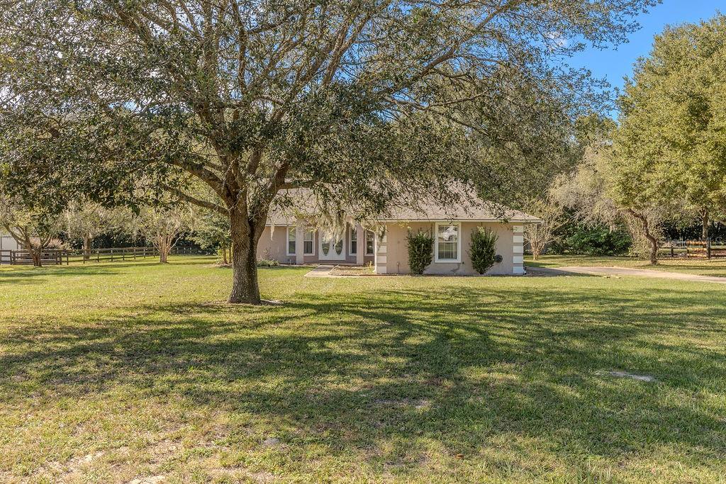 Please note this property has an Investor hold of 20 days, we cannot negotiate any non-owner occupant offers prior to 20 DOM. Owner occupant offers will be reviewed after 7 DOM. - Great opportunity to have your quiet place in the country at a phenomenal price! Situated on 1 acre, this 3 bedroom, 2 bath block home was built in 1995 and is located in prestigious Wolf Branch Village. With over 1800 sq ft under air, this home offers both living and family rooms, one with brick fireplace, formal dining room, inside laundry and a huge screened lanai. At some point, half the two car garage was converted to make the third bedroom larger so there is only a one car garage for parking and storage, but this could easily be converted back to an average sized bedroom and have your two car garage back. Septic needs to be replaced. This home needs cash or rehab loan only, but has plenty of room in the price to update and renovate to make it your own. This home has great bones and the community is top notch! All information taken from the tax record, and while deemed reliable, cannot be guaranteed. All offers to be submitted by the buyer's agent only through propoffers.com. Buyer Agent or Transaction Broker to pay $175 management fee at close of successful offer. Commission paid on net sale price.