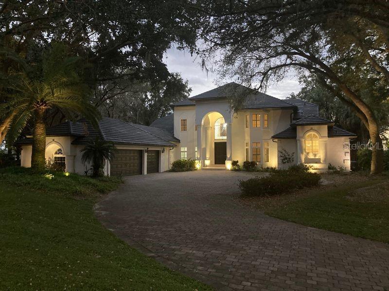 Beautiful Windermere Chain of Lakes Estate.. This Lake Down waterfront two story custom home consists of (4 Bedrooms plus Office).
Located on two incredible acres of lakefront with spectacular views of the fabulous Lake Butler Chain of Lakes.
Upon entering the home you are greeted to a wonderful view of the lake through the two story cathedral windows in the grand living area with large stone fireplace. Large chef style kitchen with cooking island and large counter tops overlooking the gracious backyard.
First floor large master suite with French doors leading out to the resort style pool, spa and outdoor sitting area with fireplace.
With over 4000 sqft. of Travertine flooring makes this the perfect home for lakefront living.
There is a Large bonus room with fireplace for added entertainment.
Upstairs consists of three large bedrooms with high ceilings and fans.
Property comes with a Covered dock w/boat hoist allowing you to enjoy one of Florida’s finest fresh water chain of lakes.
Come enjoy the life style... Room Feature: Linen Closet In Bath (Primary Bathroom).