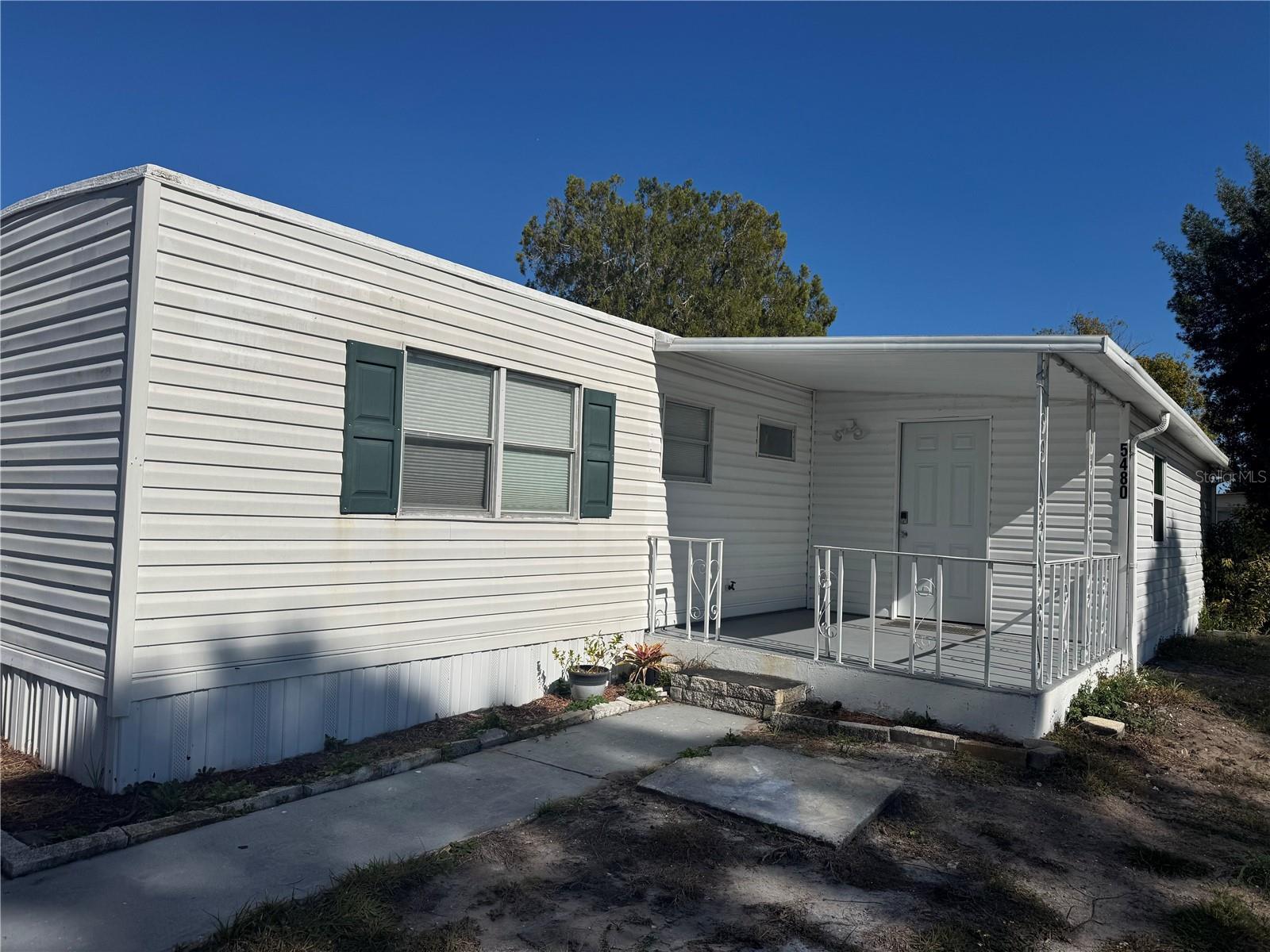 Up-to-date manufactured home built in 1971, situated on an owned corner lot in desirable Port Orange with no HOA fees. Recent updates include a new roof and new A/C. The property offers ample parking, washer and dryer hookups in the carport, and an enclosed porch that provides additional living space. Motivated sellers — all offers considered. Seller is offering owner financing, providing a great opportunity for flexible terms. Cash offers only.