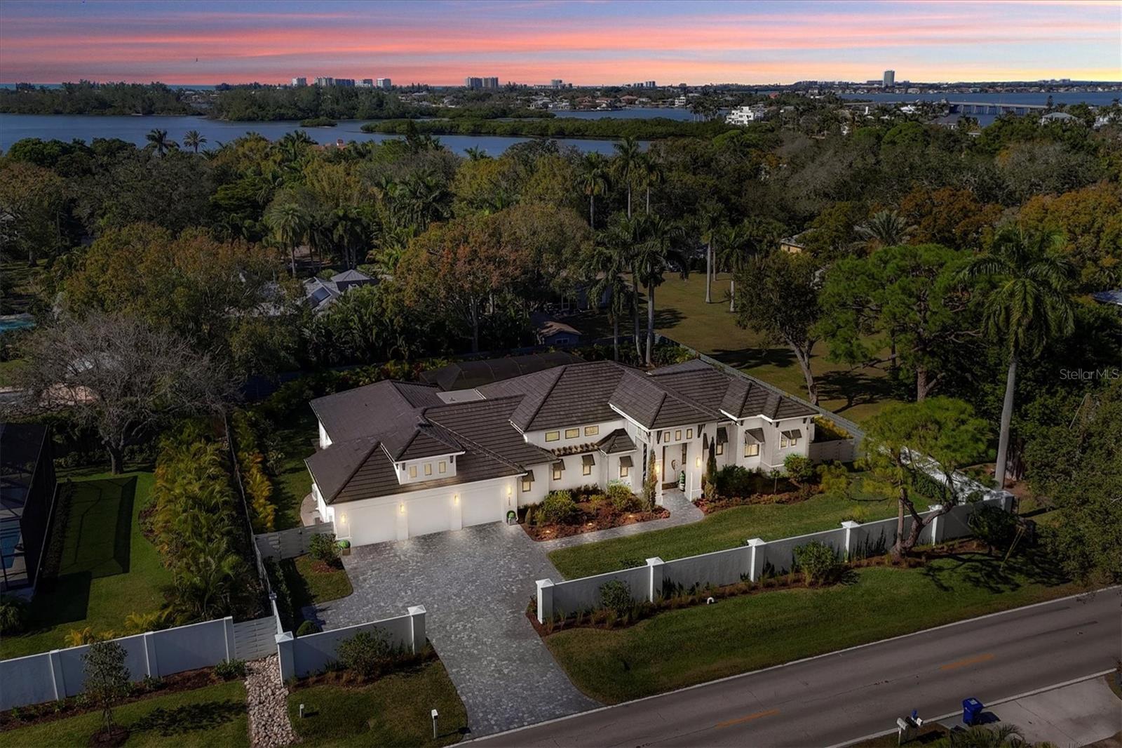 Welcome to 4050 Camino Real, a stunning property that seamlessly blends luxury and comfort. This exquisite, almost new, property boasts a prime Oyster Bay area location with picturesque surroundings, making it an ideal haven for those seeking both tranquility and convenience.
As you enter this meticulously designed residence, you are greeted by an impressive foyer that sets the tone for the entire home. The 16 foot ceilings and 10 foot pocketing sliders connect the inside living areas to the fabulous lanai.  The expansive living spaces are bathed in natural light, creating an inviting atmosphere for relaxation and entertainment. The open-concept layout seamlessly connects the living, dining, and kitchen areas, providing a perfect setting for gatherings and family moments.  The gourmet kitchen is a chef's delight, featuring Monogram appliances, Quartzite and honed Quartz countertops, custom shaker cabinetry, and ample storage space in the walk in pantry. Whether you're preparing a casual meal or hosting a lavish dinner party, this kitchen is sure to inspire culinary creativity. The master suite is a sanctuary of indulgence, offering a spacious retreat with a spa-like ensuite bath, built out closets and custom wall woodworking. The additional bedrooms are all en suite, split across the home and provide comfort and versatility, accommodating the needs of a growing family or guests. The whole home has wide plank French Oak flooring by DuChateau.  Each room is thoughtfully designed to maximize space and functionality. The home also features LuTron smart home technology with lots of built in speakers, lighting and cameras. Step outside to discover a private oasis, complete with meticulous landscaping, a refreshing saltwater pool and spa, and outdoor living spaces perfect for al fresco dining or simply enjoying the Sarasota sunshine. The property's curb appeal is enhanced by its architectural elegance and attention to detail. The home also features a number of green upgrades including impact windows and doors, a whole house generator, a well for irrigation, Icynene spray foam insulation, and an EV car charging outlet in the garage.  4050 Camino Real is not just a residence; it's a lifestyle. With its proximity to local dining, parks, cultural attractions, and some of the nations best beaches, this home offers the best of both worlds – a serene escape and easy access to the vibrant city life. Don't miss the opportunity to make this exceptional property your own. Schedule a showing today and experience the epitome of luxury living. Bedroom Closet Type: Walk-in Closet (Primary Bedroom).